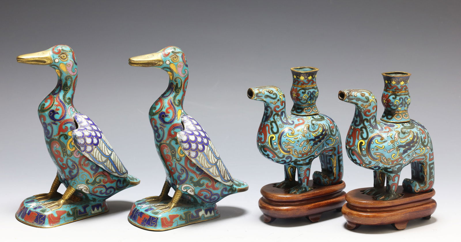 Chinese Cloisonne Birds: Late Qing to Republic period Chinese cloisonne grouping with a pair of duck figures and a pair of phoenix figures, decorated with polychrome scrolling motifs on turquoise ground, the phoenixes raised