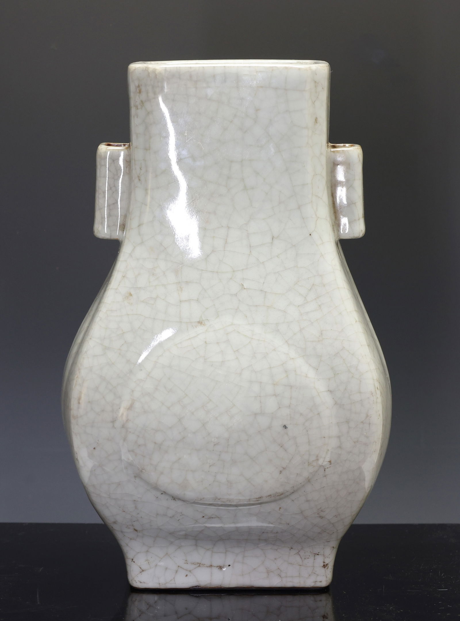 Chinese Crackle Glaze Hu Vase: Qing era celadon Guan type vase with tubular handles, cut corners, raised panels to the bulbous body, and rectangular foot with a brown rim. Underglaze cobalt Qianlong seal mark to the foot. The