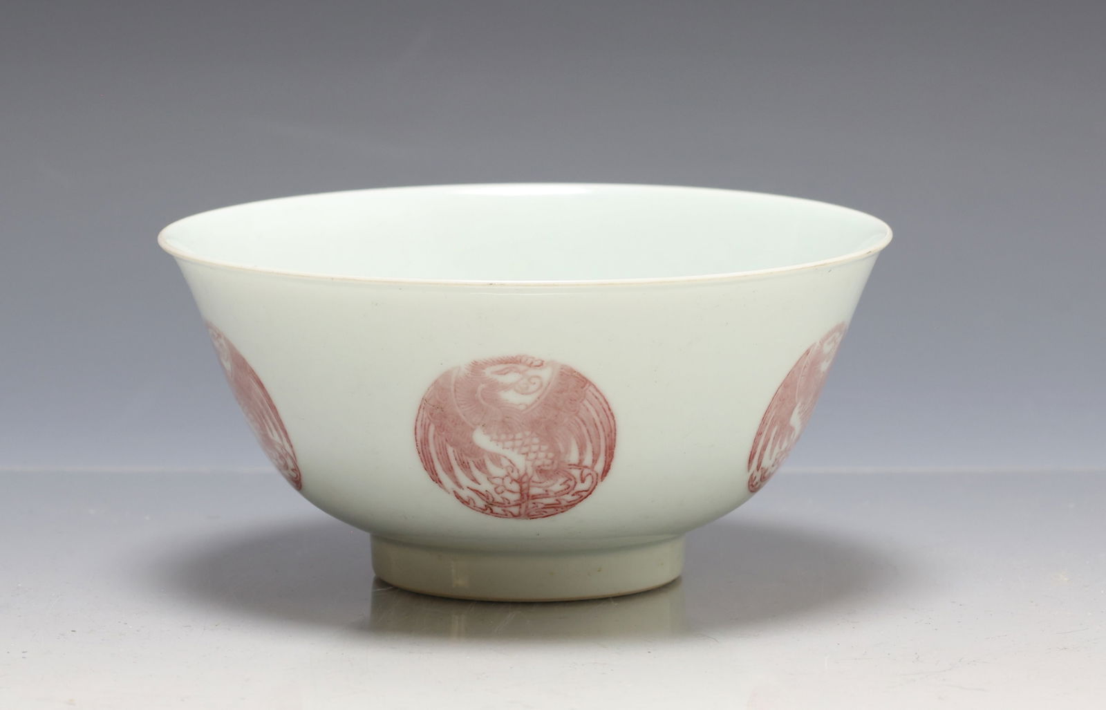 Chinese Phoenix Medallion Porcelain Bowl: Qing era porcelain bowl with iron red phoenix form medallions to the exterior sides and interior center. Daoguang reign seal mark to the foot. 3"h x 6"w