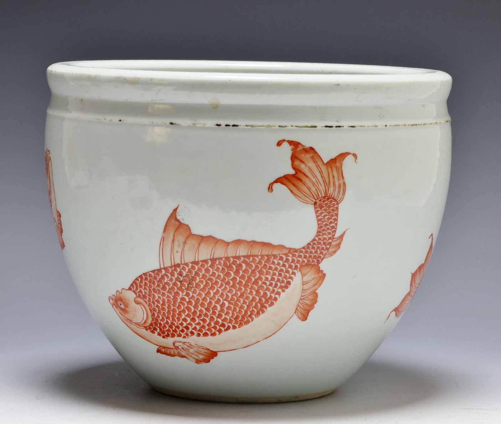 Chinese Iron Red Fish Porcelain Jardniere: Qing era porcelain fish bowl / jardiniere with iron red fish decoration to the exterior. Unmarked. 7.25"h x 9.5"w