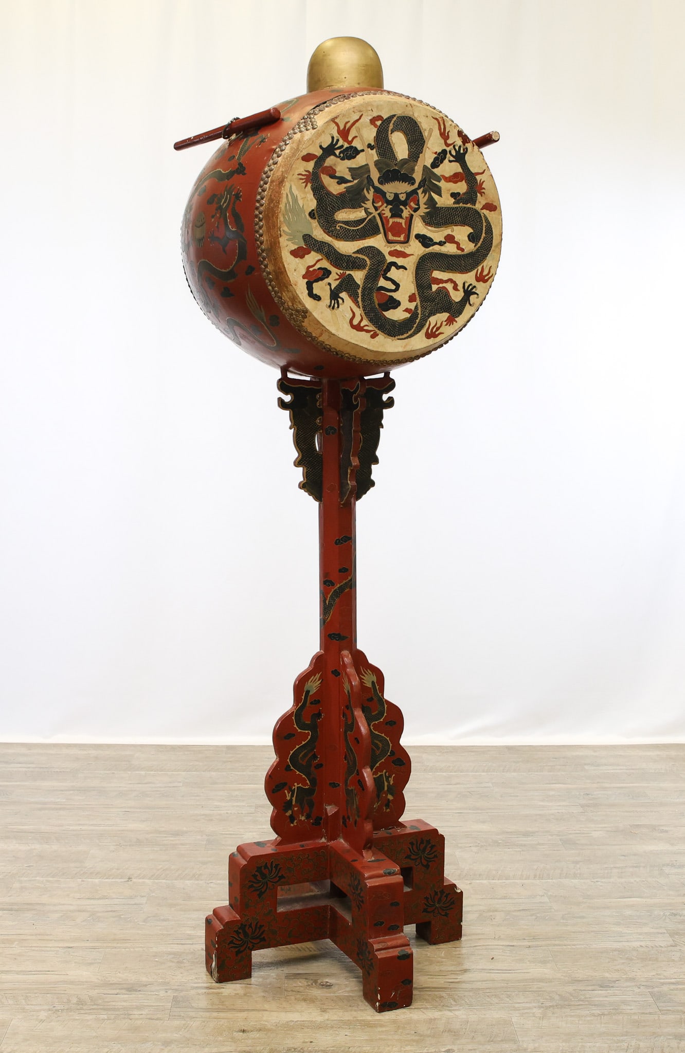Chinese Ceremonial Drum on Stand: Late 19th to early 20th century, Chinese lacquered ceremonial drum on stand, with the barrel form drum decorated with a five toe dragon and foliate motifs, mounted on a carved and lacquered pedestal
