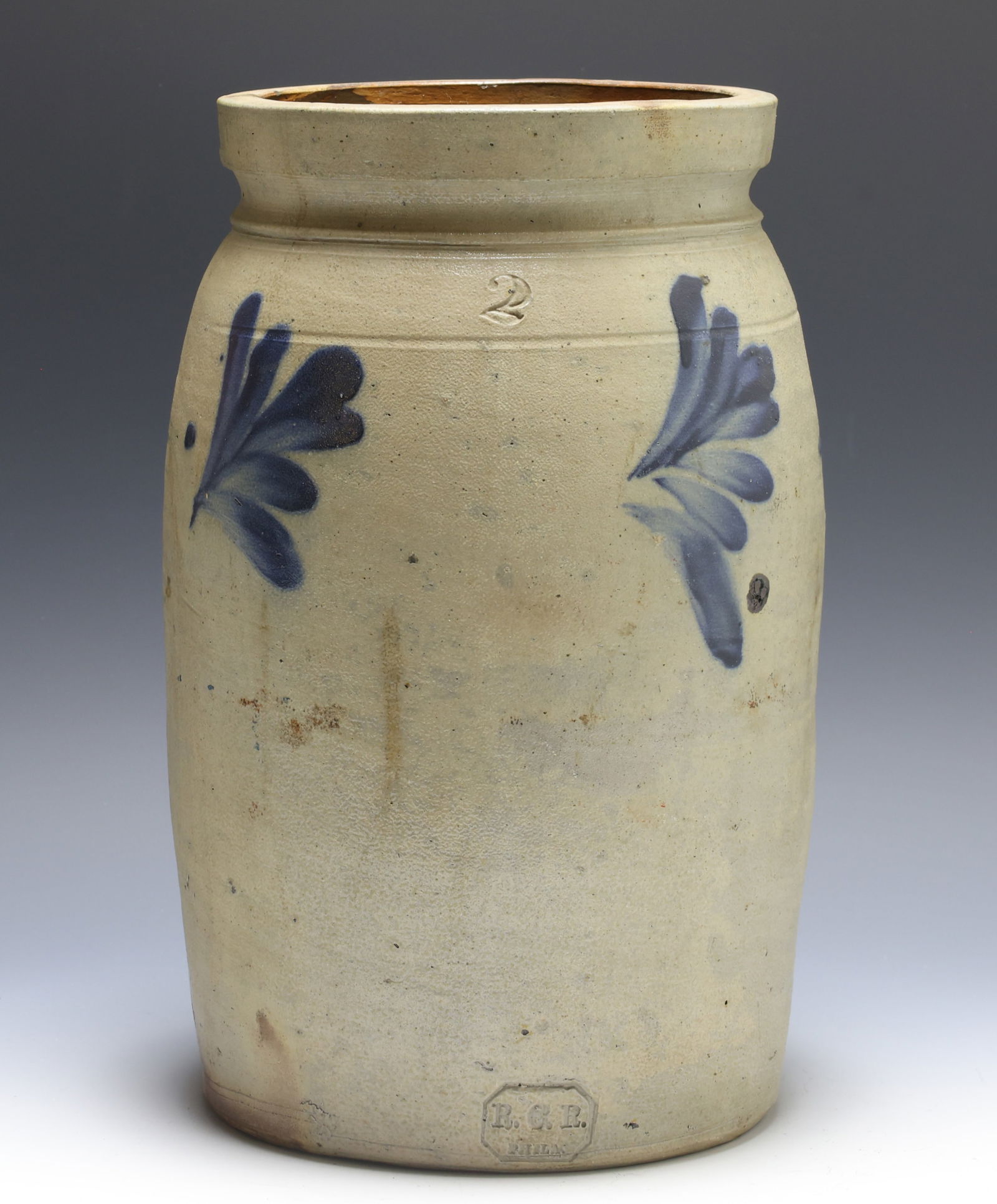 Richard C. Remmey Stoneware Jar: Pennsylvania salt-glazed stoneware jar with impressed “2” on collar and “R.C.R. Phila” on foot. Cylindrical jar/crock having a flared tooled shoulder and decorated with brushed cobalt