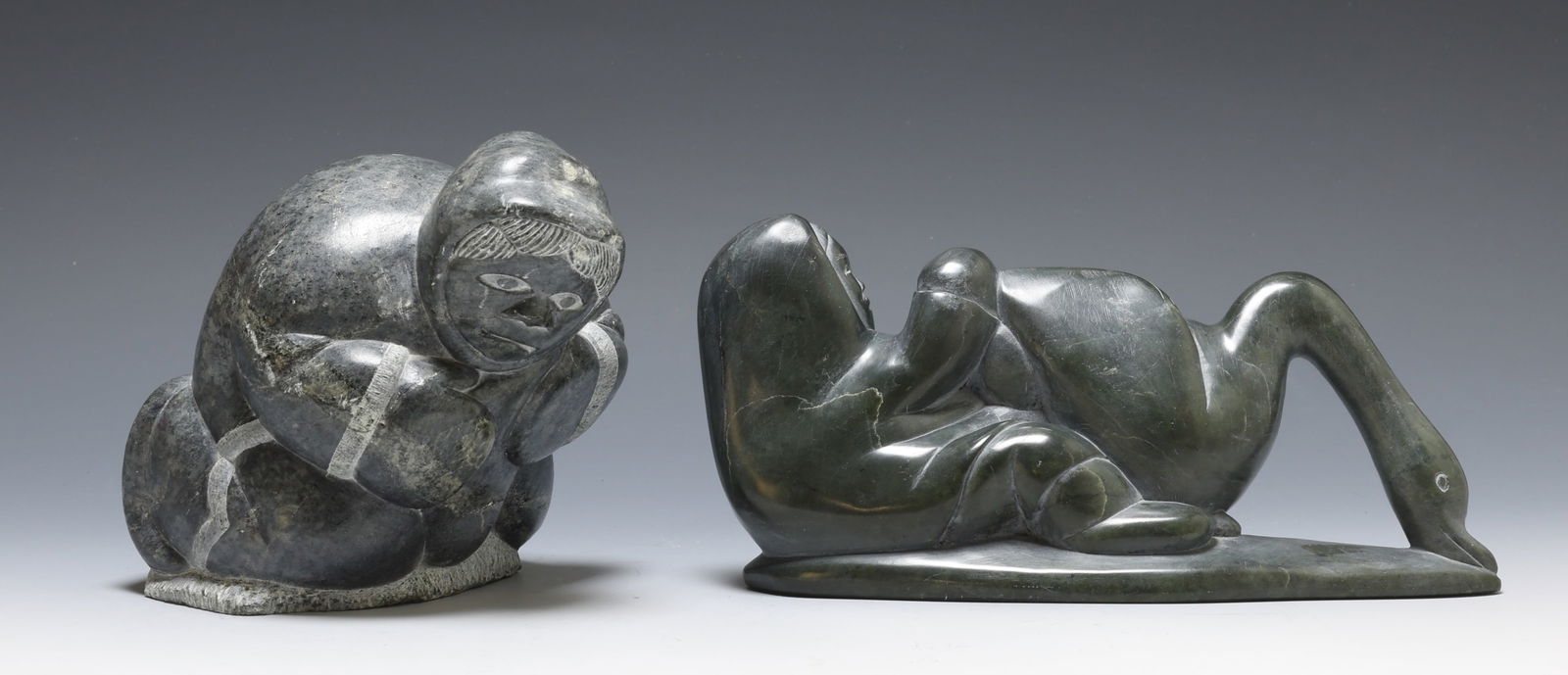 Inuit Carved Sculptures: Carved soapstone sculptures by Inuit artists. Samson Kingalik (1937 - 2011), a figure with a swan, Port Harrison / Inukjuak, signed in Inuktitut syllabics, dated 2001, numbered C5-76678, with Canada