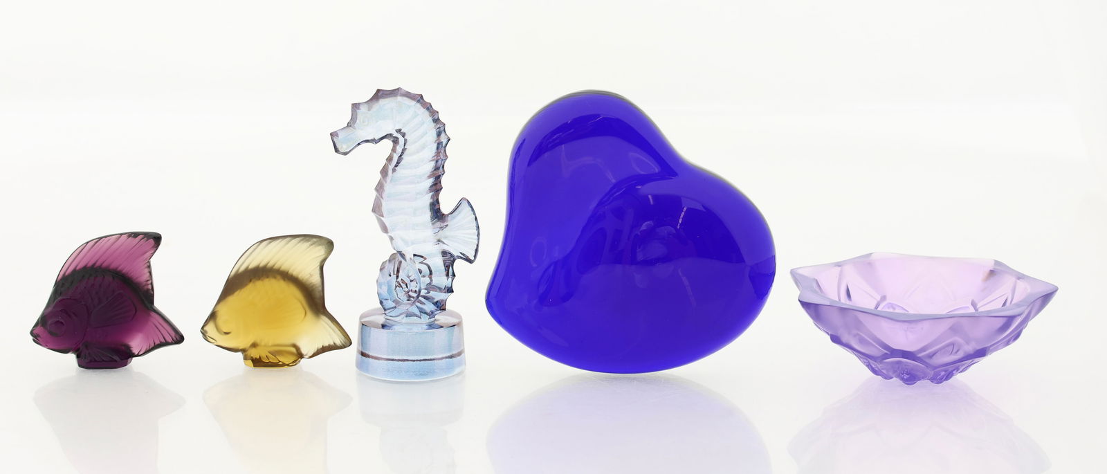 Lalique Crystal and Elsa Peretti for Tiffany Glass Accessories: French crystal items by Lalique, including a "Nyphea" violet dresser bowl, 1.25"h x 3.5"w, "Poisson" fish sculptures (2) in violet and gray, 2"h, and a "Hippocampe" seahorse sculpture in blue lustre,