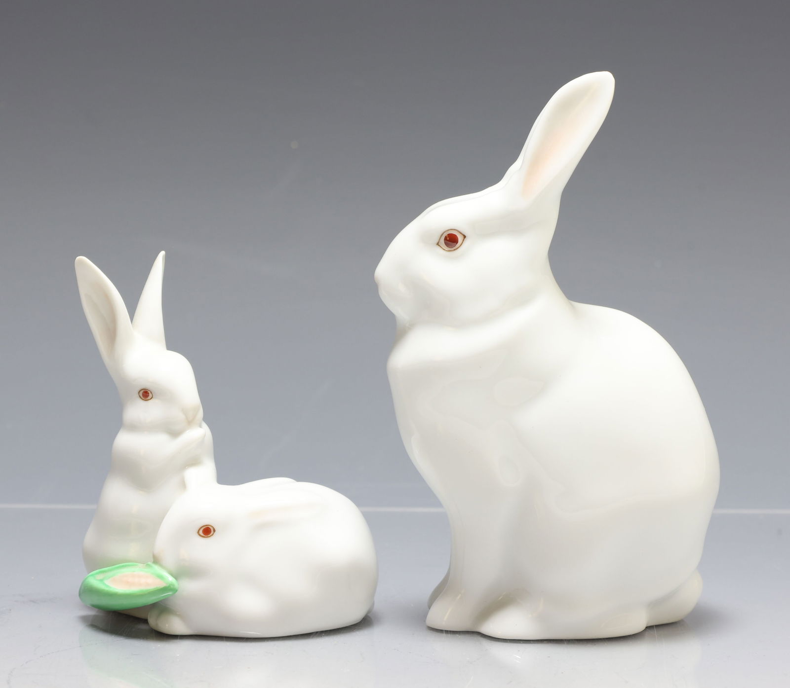 Herend Porcelain Rabbit Figurines: Hungarian porcelain figurines, including "Pair of Rabbits with Corn" and "Rabbit - Natural/White". (2) figurines. 3.5"h x 3"w x 2"d and 5.25"h x 1.75"w x 2.75"d