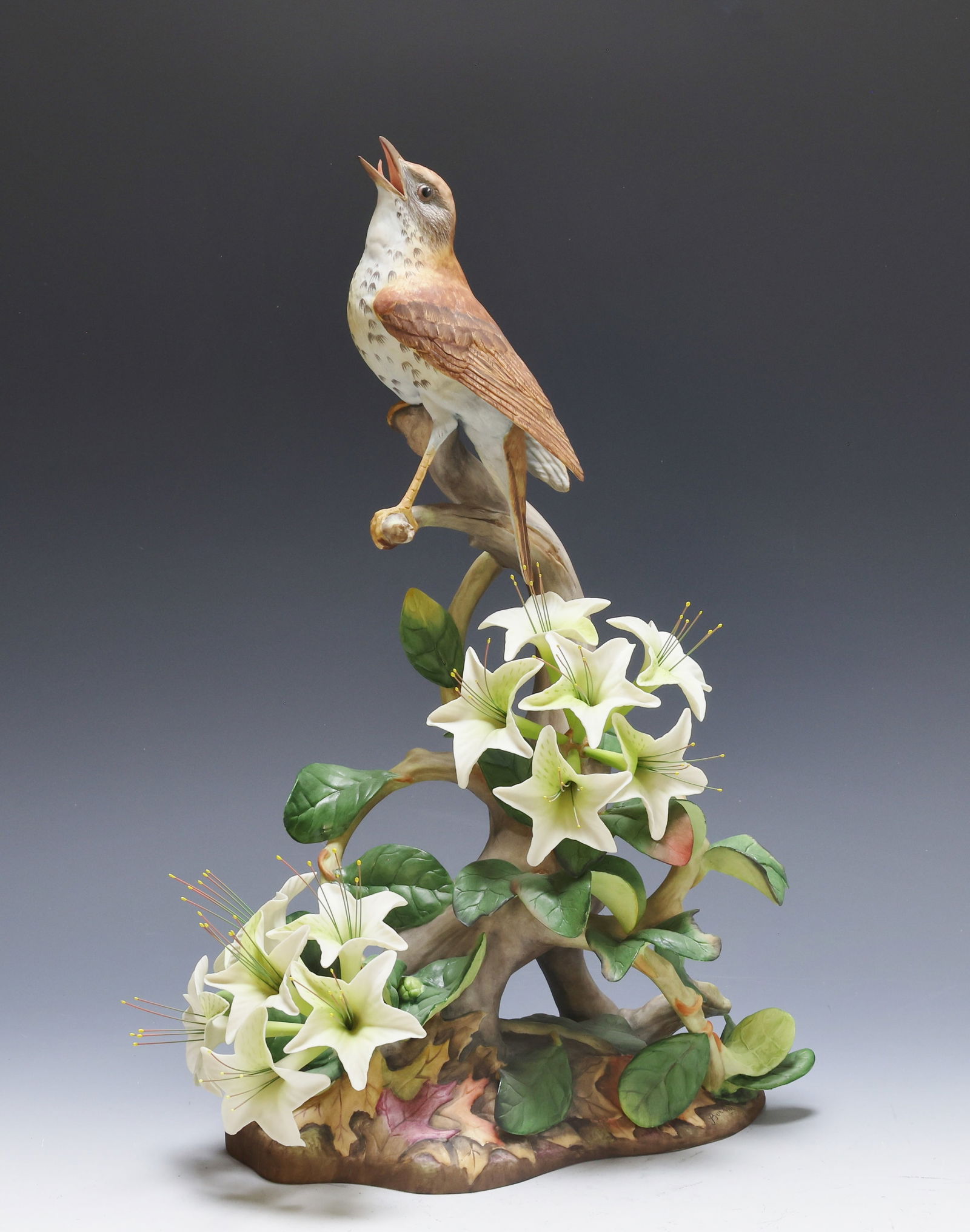 Boehm Porcelain Wood Thrushes: Boehm birds “Wood Thrushes-Hylocichla Mustelina, 485”, limited edition, marked on bottom. Male bird perched on a spray of open flowers. 16"h x 11"w x 5"d