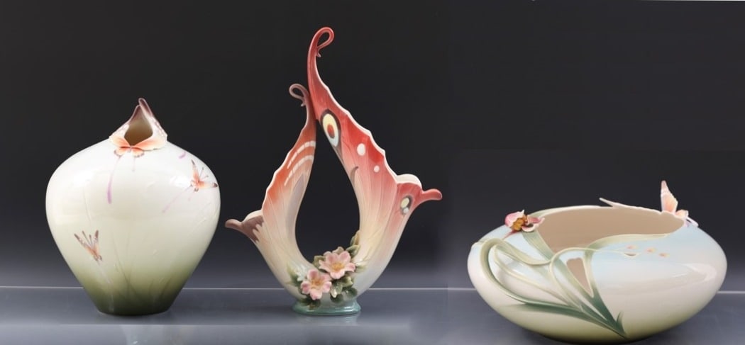 Franz "Papillon" Porcelain Vases: Modern China decorated with butterflies and flowers, including a low round vase (5.75"h x 12.5"w) with original box, a tall narrow necked vase (11.5"h x 9"w) with original box, and a double vase