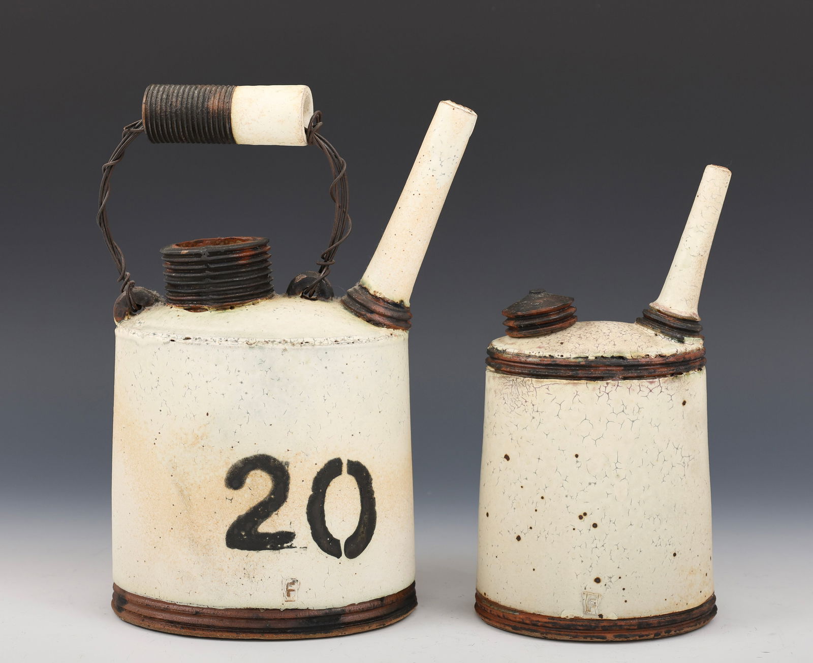 Nathan Falter for Springfield Pottery Sculptures: Abstract stoneware sculptures, one with wire, "Oil Cans", each with an impressed initial to the side. (2) pieces. 9.5"h x 4"w x 5"d, and 10"h x 4.5"w x 7.5"d