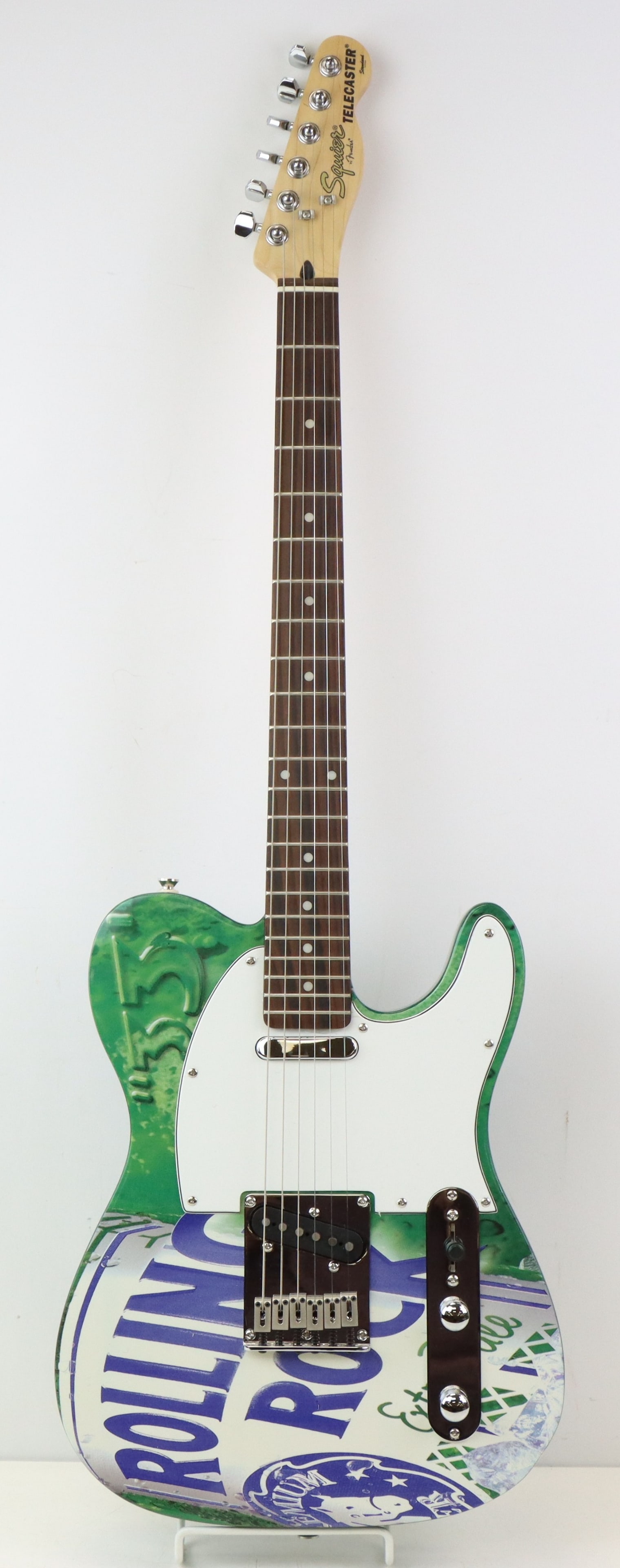 Squier by Fender Electric Guitar: Squier by Fender 20th Anniversary Rolling Rock Beer Tribute Telecaster. Metallic Green. Like New. Serial Number IC021005748 (Indonesia). Molded Hardshell Case 40.75"h x 15.5"w x 4.75"d.