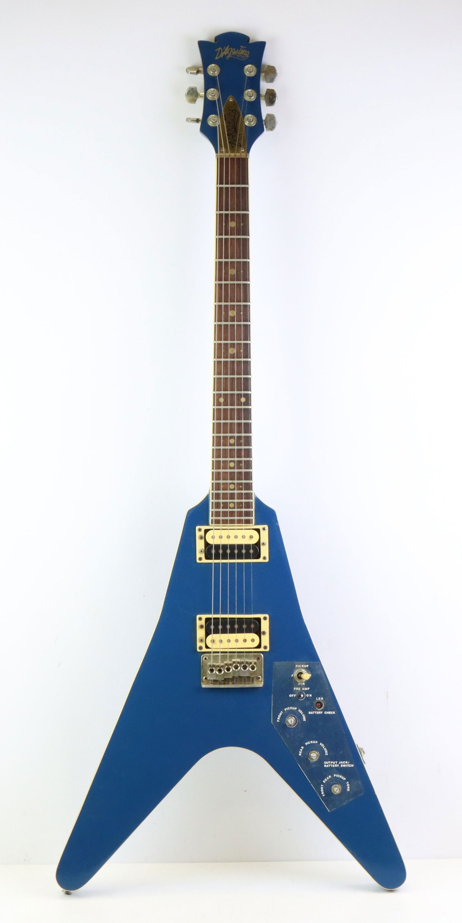 D'Agostino Electric Guitar: D'Agostino "Flying V" Electric guitar. c. 1980's. Rare example. Blue with off-white binding.Original knobs but not attached. Electronics in need of service. Additional POT and 1/4" jack needs to be