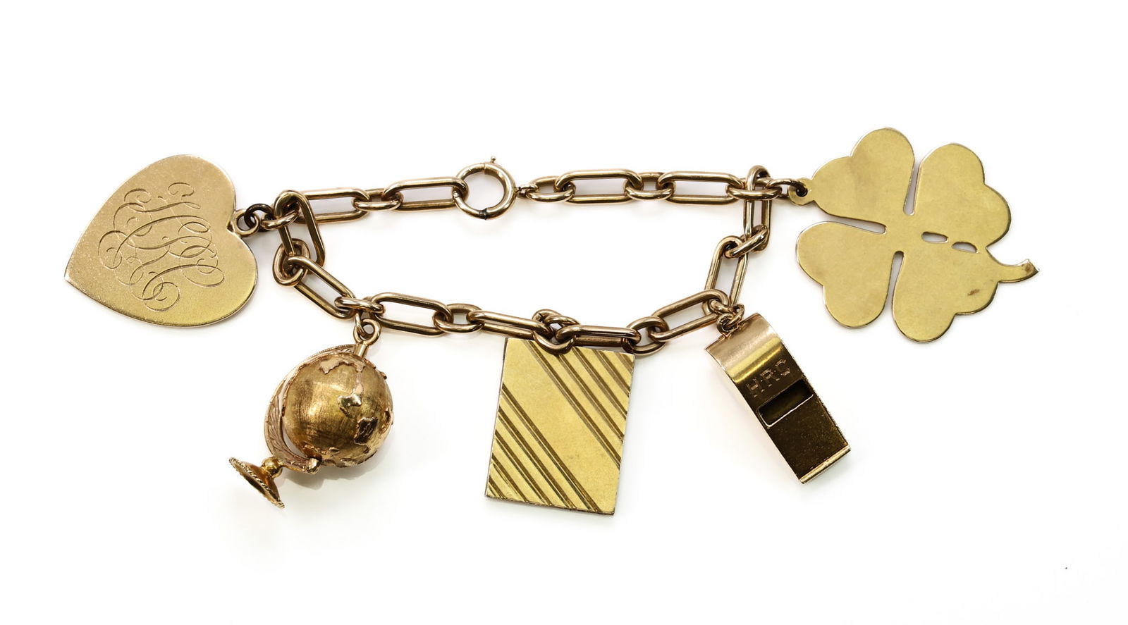 14k YG Charm Bracelet: 14k yellow gold charm bracelet with assorted charms including engraved heart, four-leaf clover, whistle, striped plaque, and globe (globe tests 18k; remaining charms marked or tested 14k). 7" and