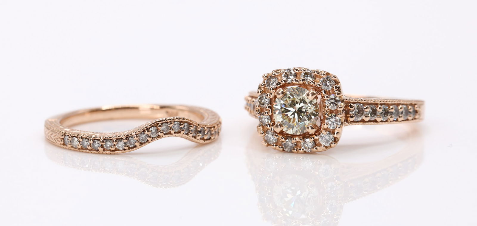 14k RG Diamond Wedding Set: 14k rose gold two piece wedding set with a round brilliant cut diamond weighing approximately .60 carat, surrounded by round brilliant cut accent diamonds totaling approximately .50 carat. Size 6.25