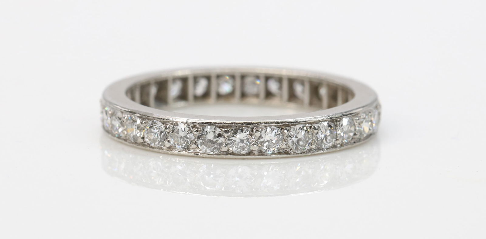 Platinum Diamond Eternity Band: Platinum eternity band set with (29) round brilliant cut diamonds totaling approximately 1.0 carat. Ring size 5.25. 2.2 dwt.