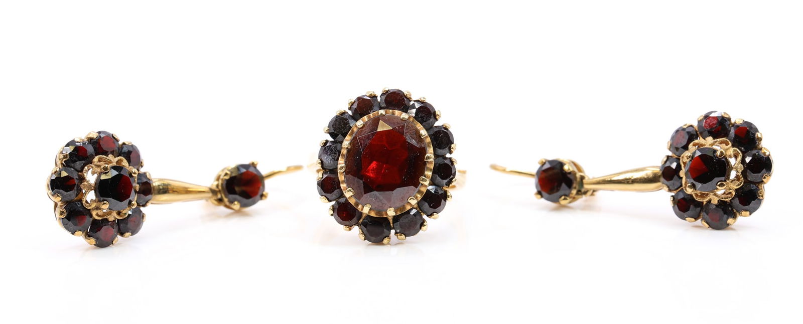 18k YG Garnet Suite: 18k yellow gold garnet ring set with approx. 5.0 ct oval garnet and approx. 2.5 cts garnet accents, size 7.5, 5.3 dwt; together with 18k yellow gold garnet drop earrings set with approx. 2.5 cts