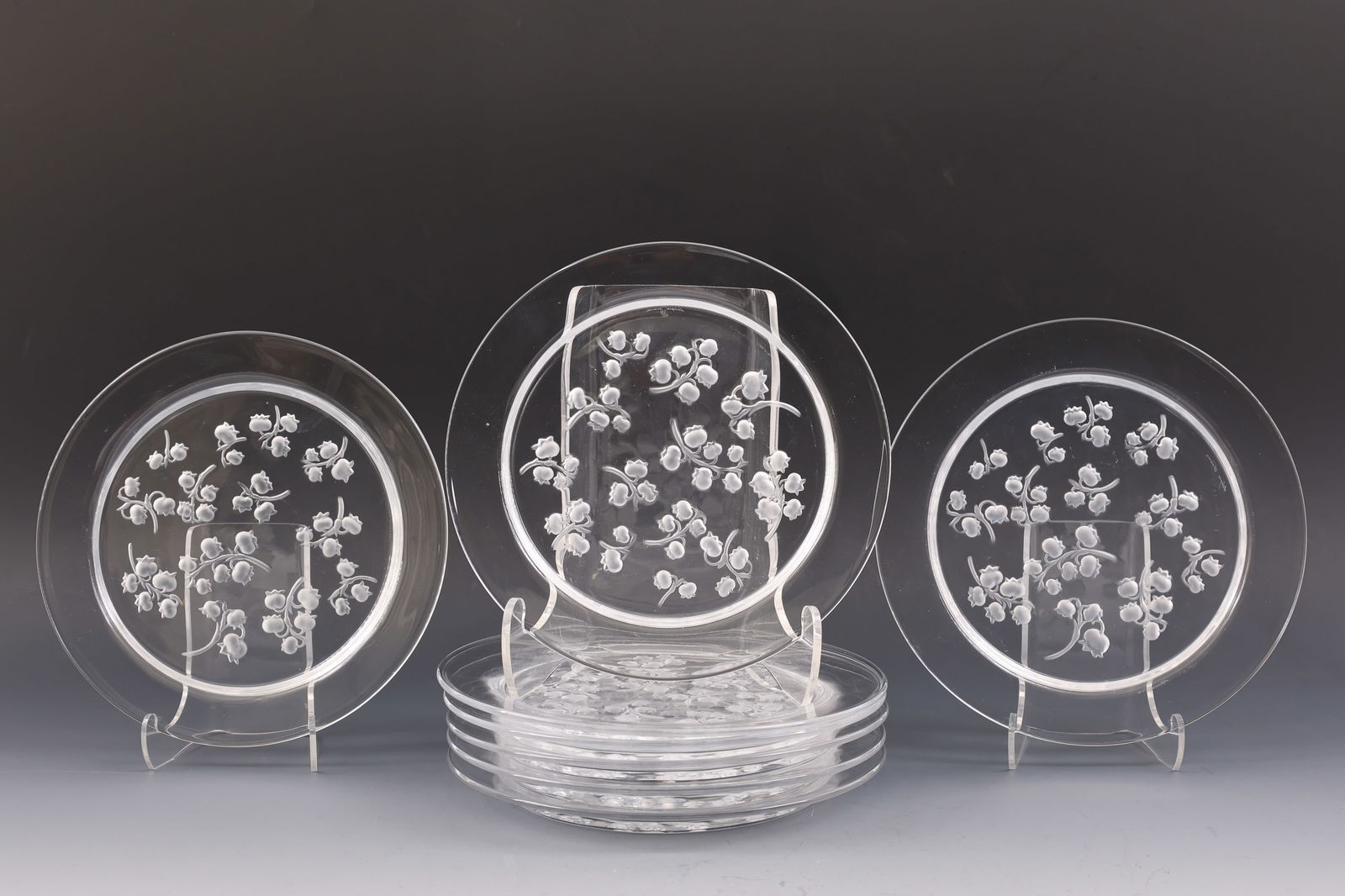 Lalique "Muguet" Salad Plates: French molded crystal salad plates, frosted lily of the valley motif on a clear background, with engraved markings. A set of (8). 8.25"w