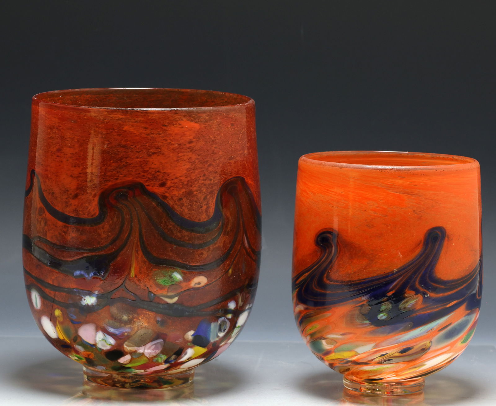 Peter Reynolds Art Glass Vases: Australian art glass vases decorated with pulled feather, agate, and textured motifs over a reddish-orange ground invoking the natural environment. The larger hand marked Nor. W. Aust. and with