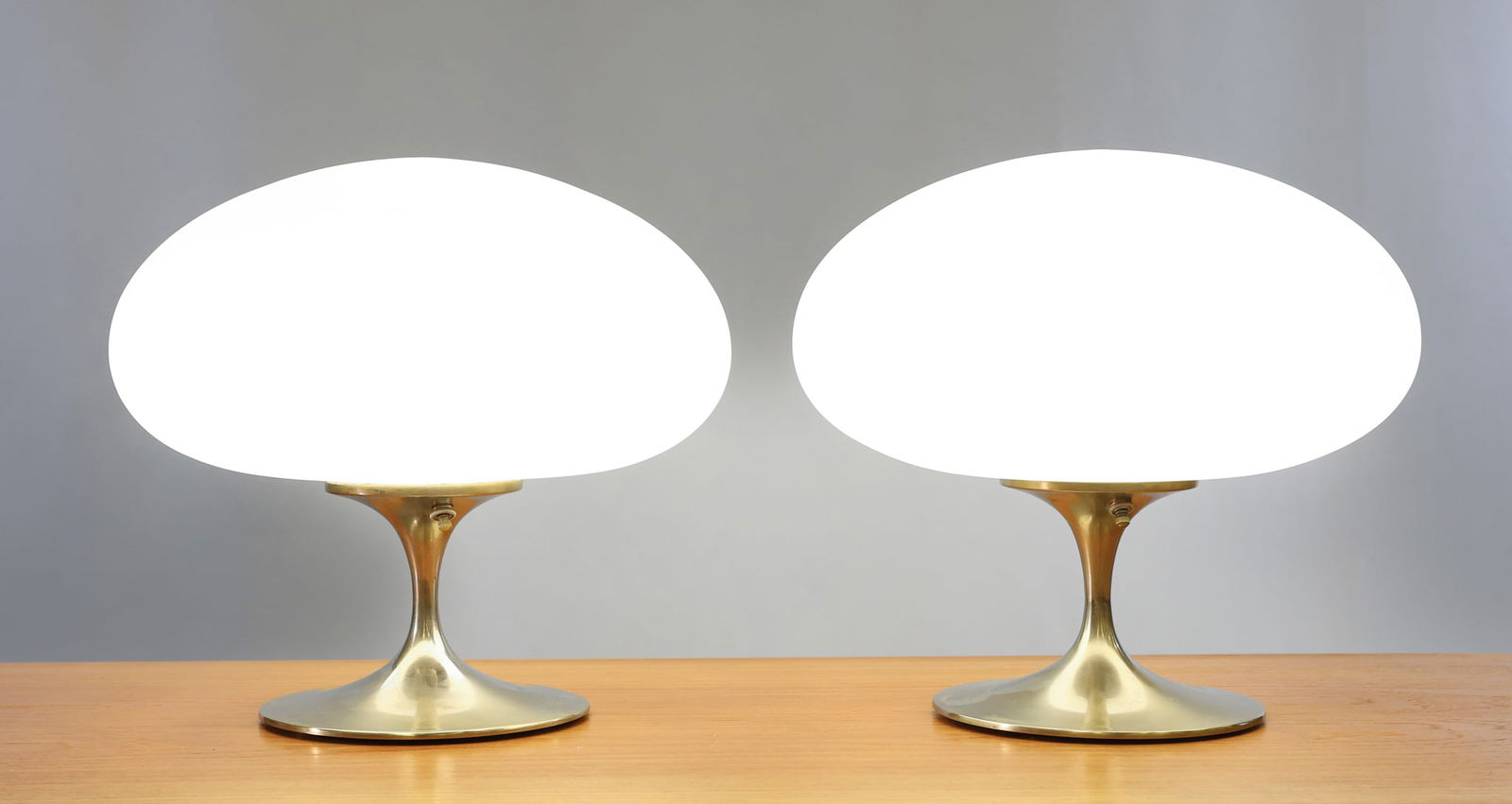 Richard Barr for Laurel Mushroom Lamps: Model V-809 pair of "Ac-cent" mushroom lamps with satin chrome bases and satin white cased glass oval shades, labeled for Laurel and stamped with patent no. 199.141. In working condition. Some