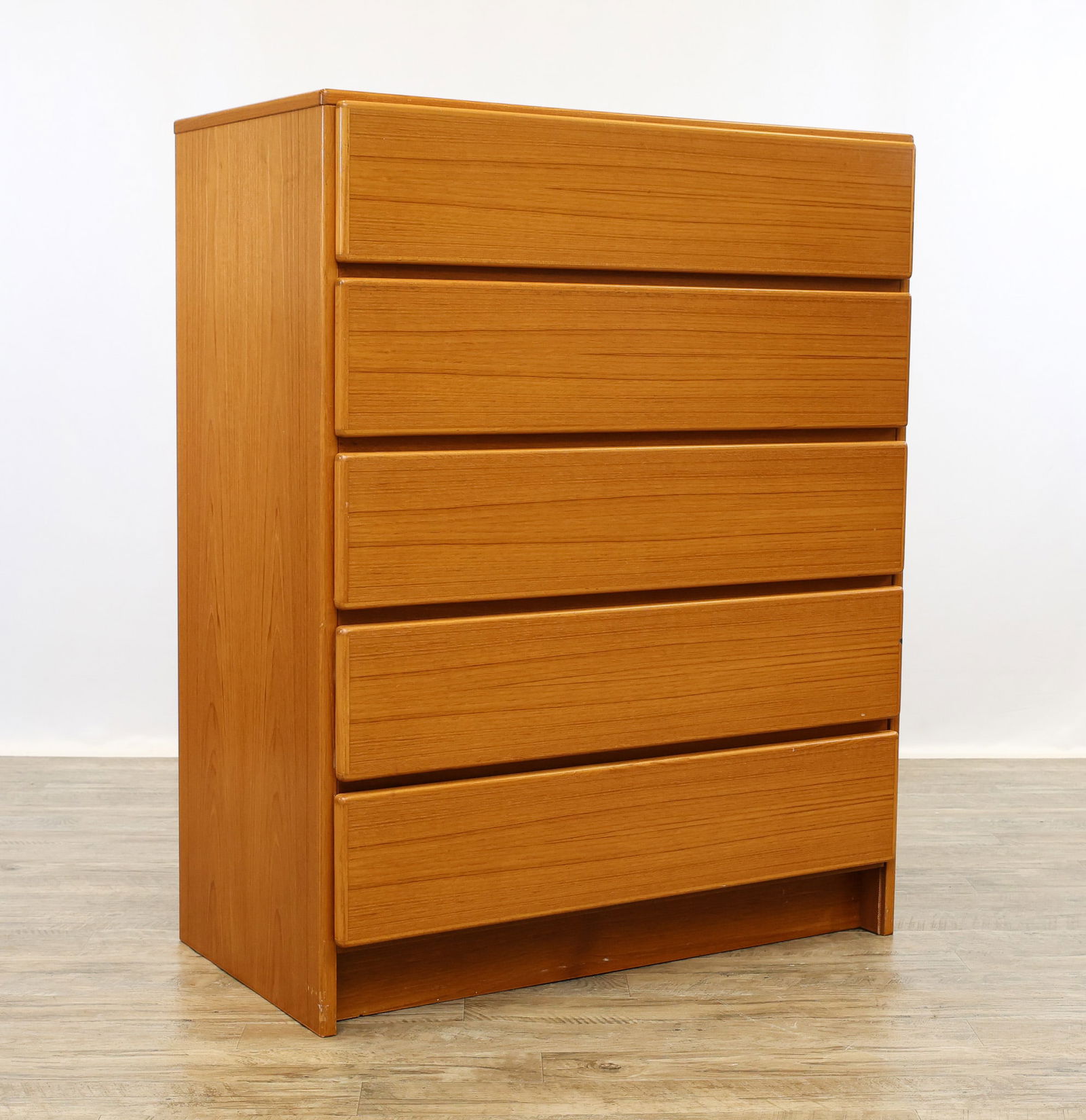 Scan Coll Teak High Dresser: Danish Modern teak dresser with five drawers, the top fitted. Labeled. Scattered surface wear including scuffs/scratches, and some minor loss at the base; plaster and tape residue on the back. 45"h x