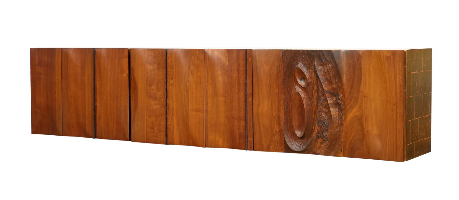 Phillip Lloyd Powell Cabinet: Bucks County, Pennsylvania, sculpted walnut wall mount cabinet, featuring two tri-fold doors which open to two storage spaces with shelving, beside a fall front storage space with white laminate to