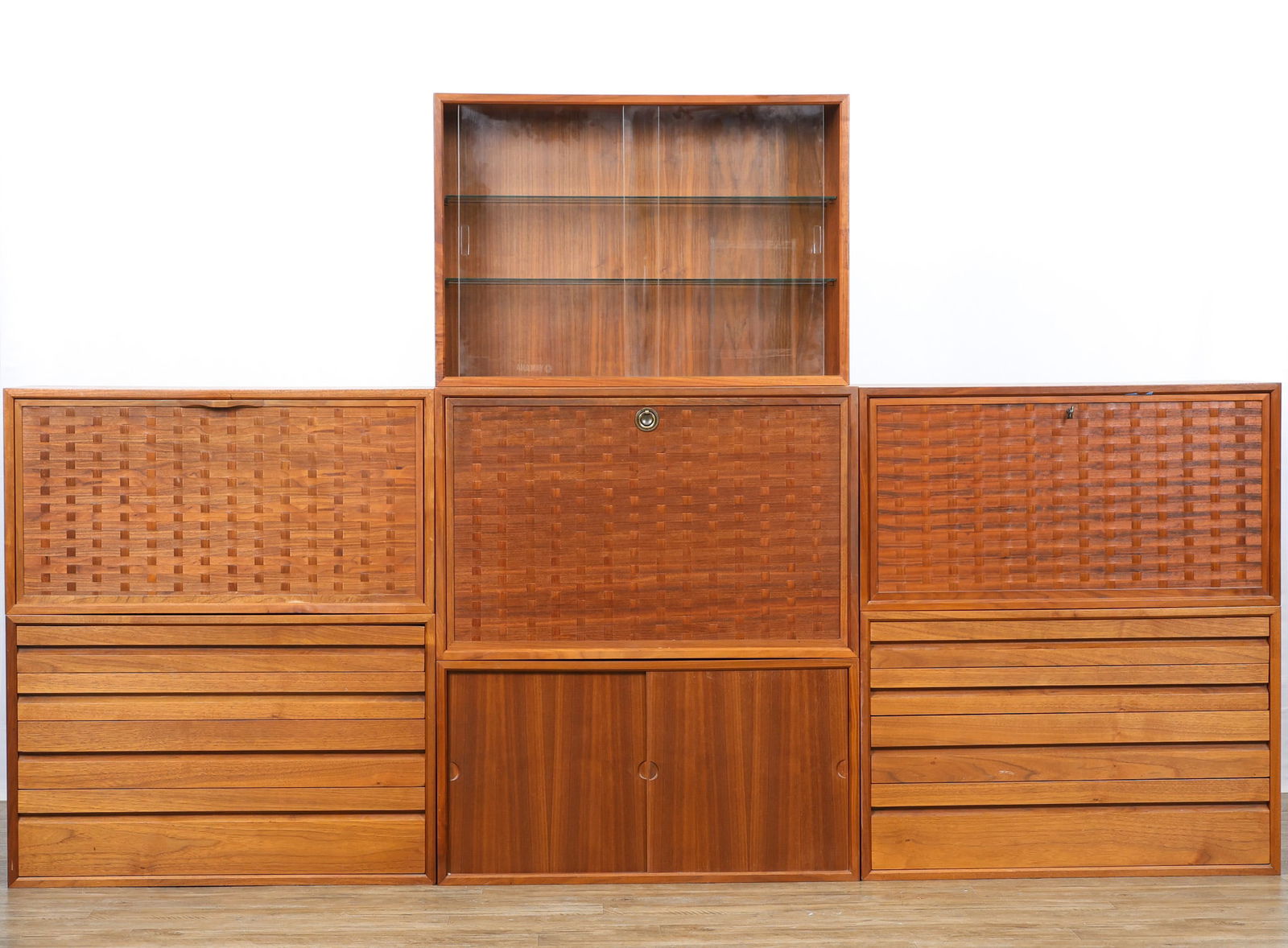 Poul Cadovius for Cado "Royal System" Modular Wall Unit: Danish Modern wall unit, assembled from two releases, including a module with a locking basketweave drop-front which opens to storage space and pull-outs (16.5"h x 31.5"w x 15"d), a similar module