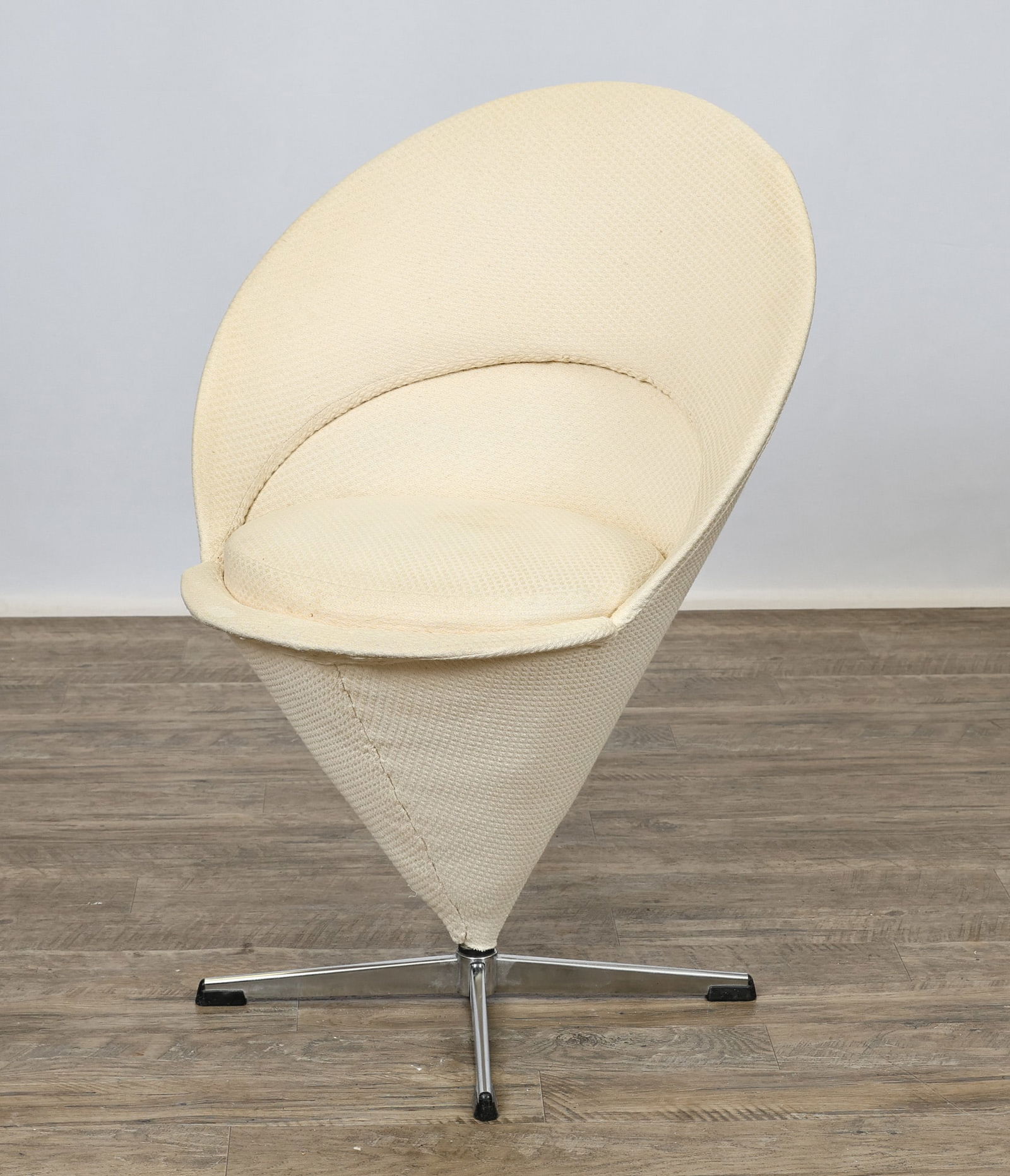 Verner Panton "Cone" Chair: Danish Modern cone shaped chair with a removable seat which opens to a white coated steel interior, chromed steel four-star base with plastic glides, and white fabric upholstery. Unmarked. 33"h x
