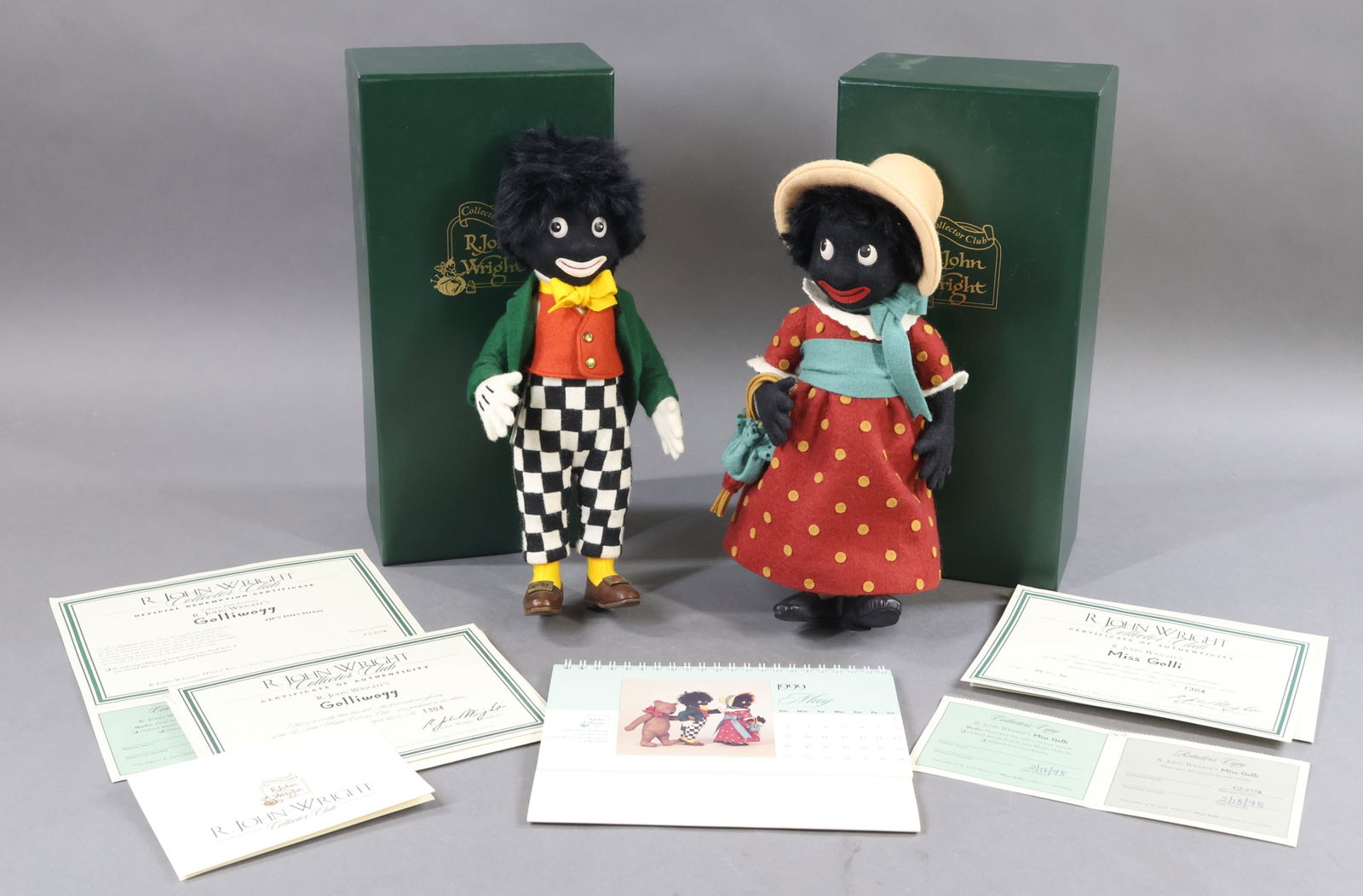 R. JOHN WRIGHT.: Pair of 1997 Collector's Club Dolls in OB. 10" MINT "Golliwogg", 1304/2500. COA. 10" MINT "Miss Golli", 1304/2500. COA. 1999-2000 Collector Club Calendar. This lot is being sold AS IS.