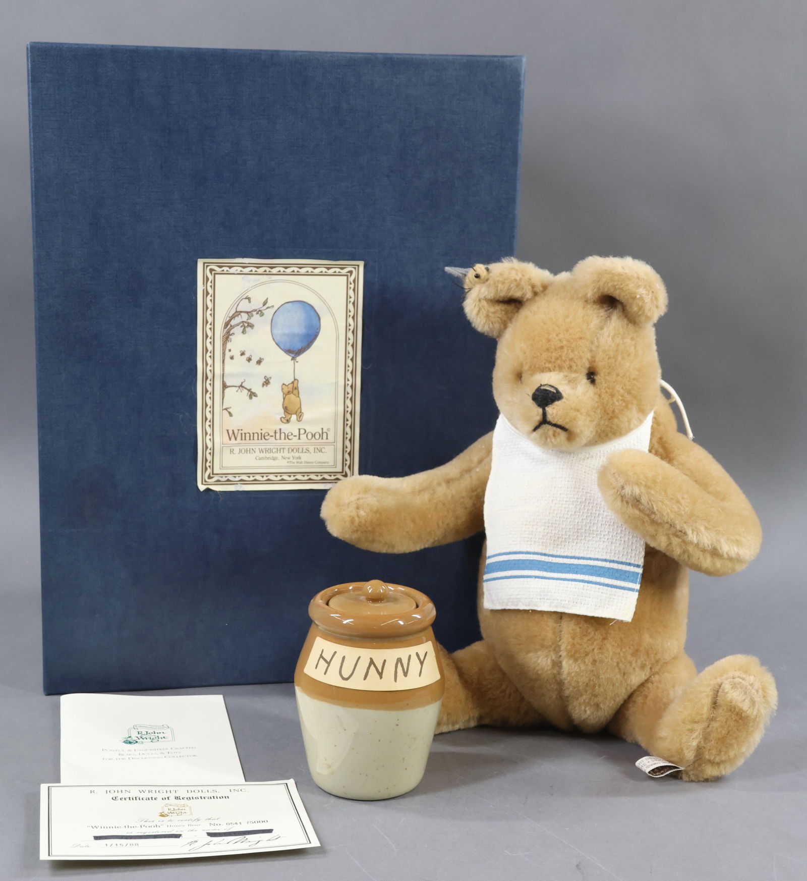 R. JOHN WRIGHT.: 14" 1988 Winnie-The-Pooh "Honey Bear" in OB. Ltd. Ed. 0541/5000, COA. This lot is being sold AS IS.
