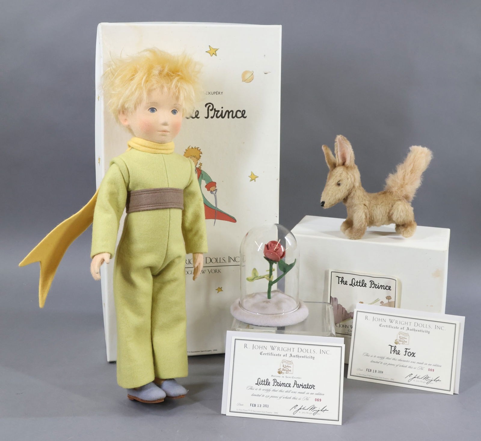R. JOHN WRIGHT.: LOT. 15" 2003 "The Little Prince Aviator" in OB, , 069/250, COA. Condition: doll is MINT, box lid has age loss. Also - he comes with a 4" glass dome with felt rose which he watches over. 5" 2004 "The