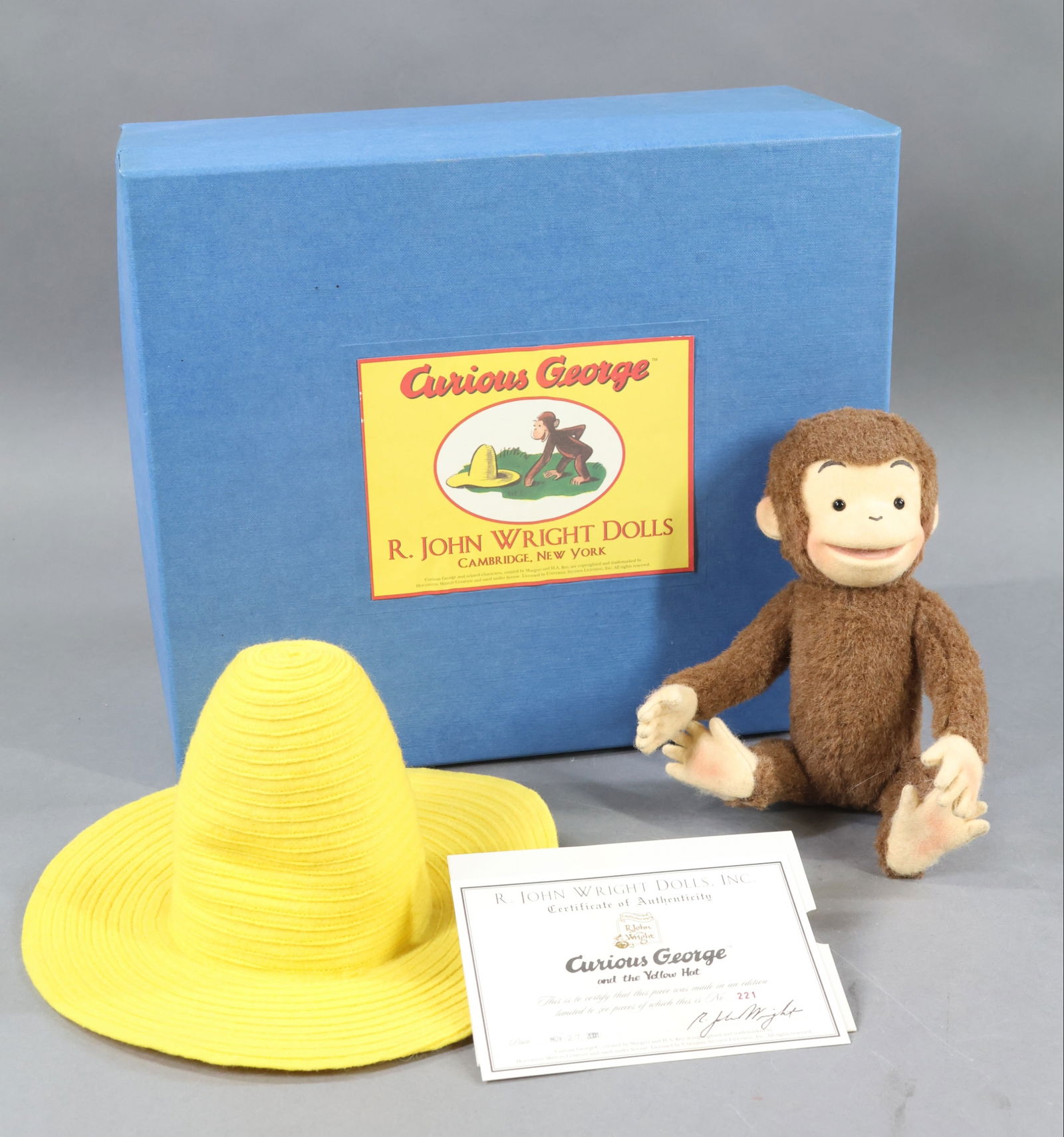 R. JOHN WRIGHT.: MIB 9" 2001 "Curious George & The Yellow Hat". 221/500, COA. This lot is being sold AS IS.