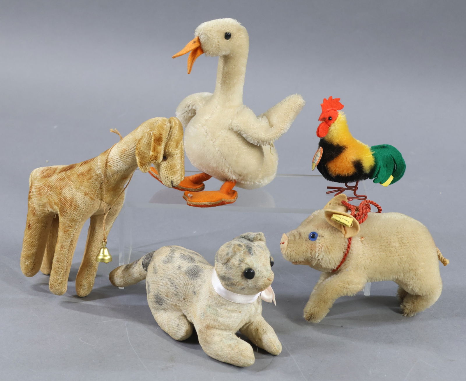 VINTAGE STEIFF/OTHER.: LOT. STEIFF- 5" L. pale pink mohair "Pig" with blue glass eyes. Raised silver button, yellow tag, 1310.0. 6" T. White mohair "Duck" with orange felt bill, feet. Black glass eyes. Raised silver button,