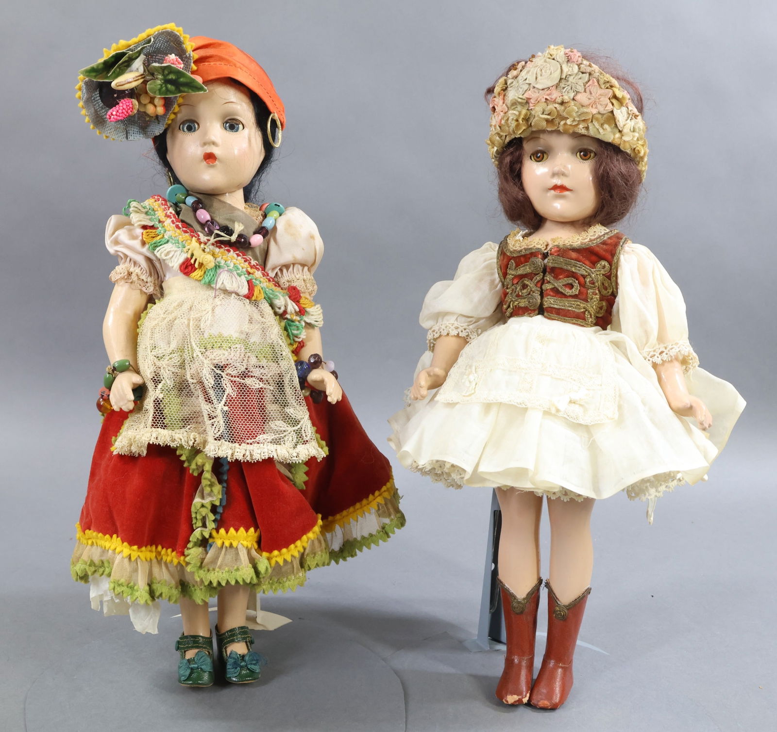 COMPOSITION DOLLS.: Pair of 15" all original Costume Dolls with sleep eyes, closed mouths, mohair wigs. Doll 1) Madame Alexander 1942 "Carmen Miranda" type doll with the Wendy Ann face. Black hair. Green oilcloth shoes.