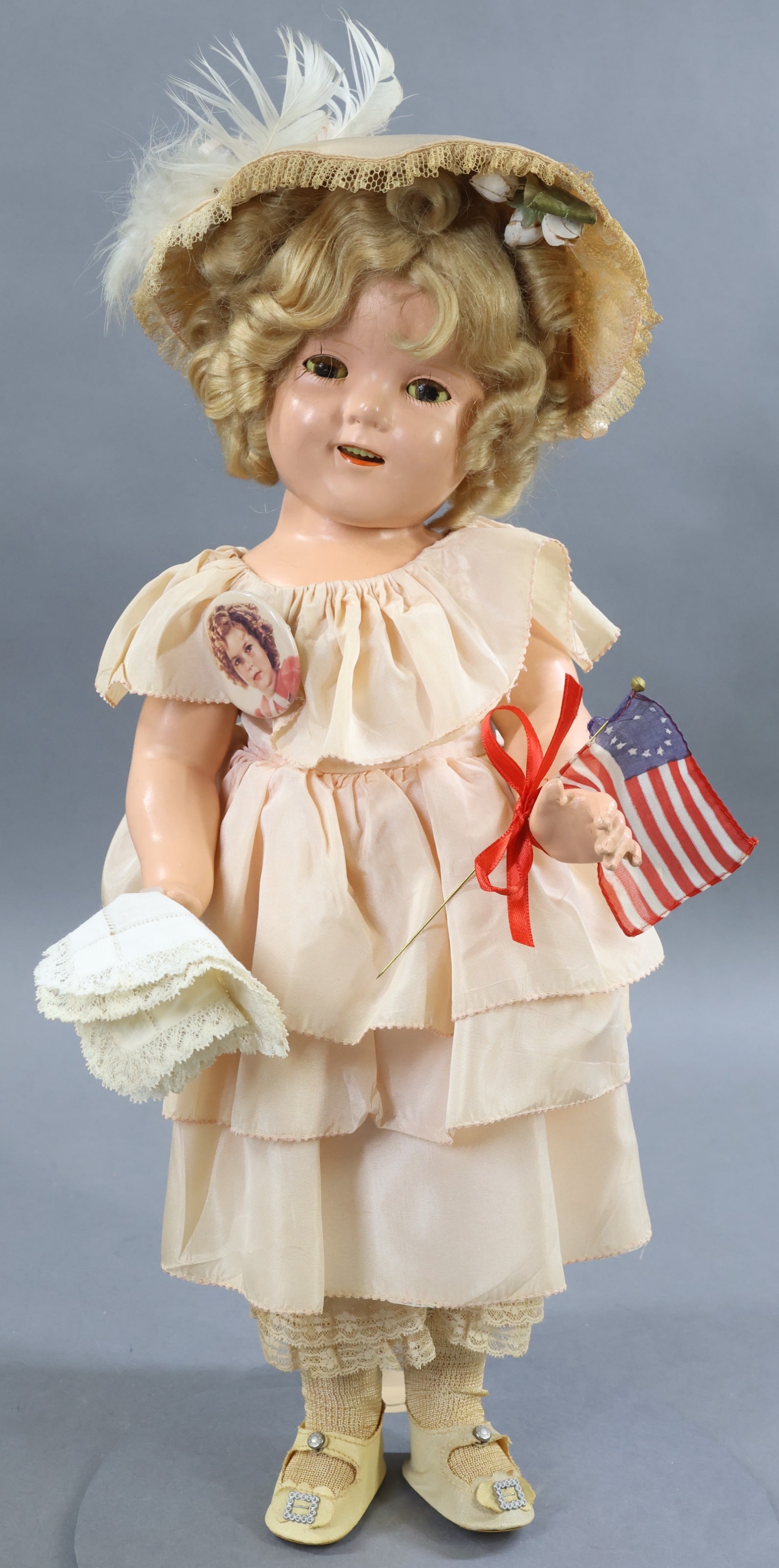 COMPOSITION DOLLS.: 18" All original IDEAL "Shirley Temple" doll dressed in "Southern Belle" costume. Original honey blonde mohair wig. Dressed in pale pink taffeta layered dress with matching pantaloons and decorated bo