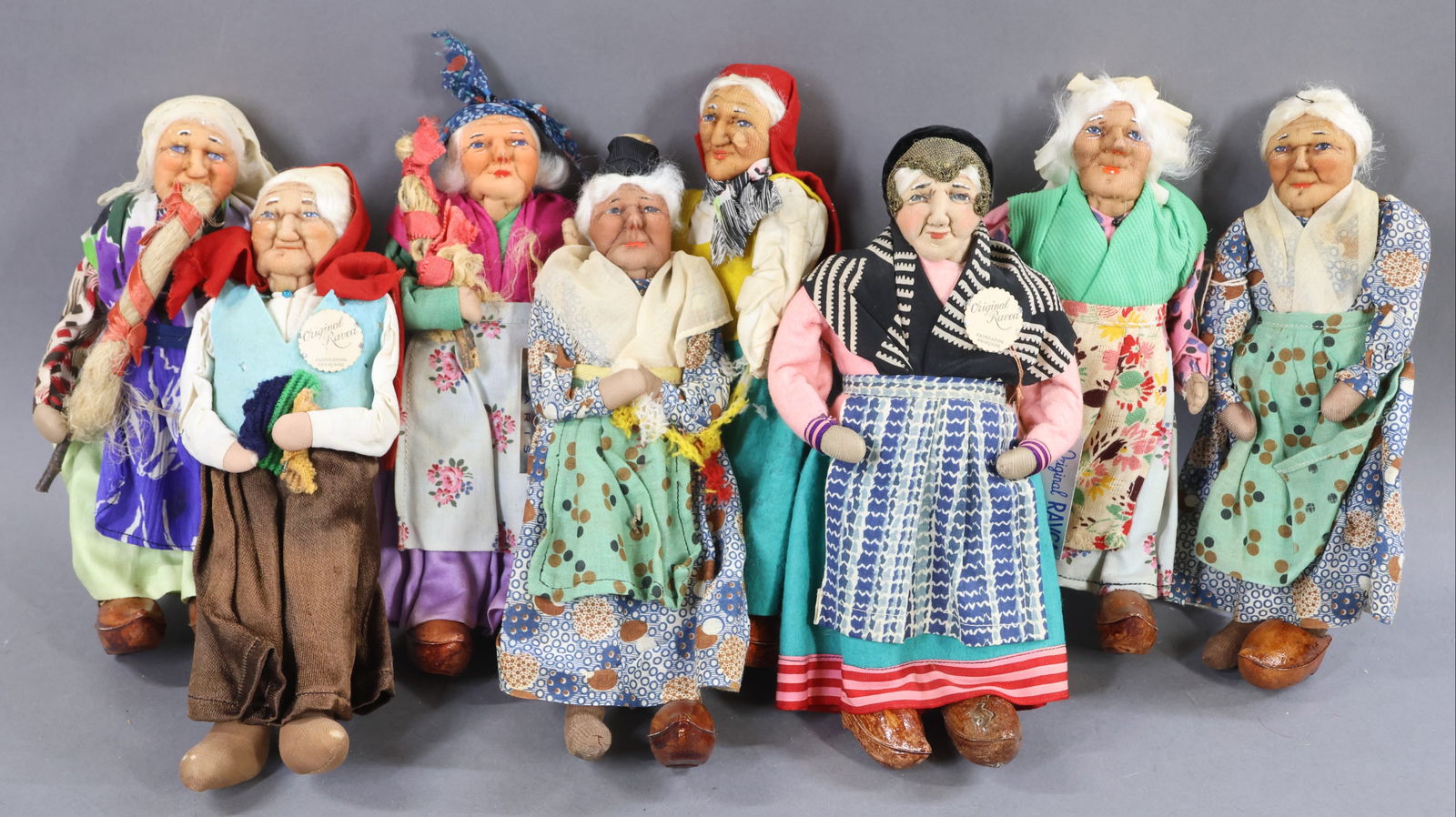 RAVCA.: LOT of (8) 10" Elderly Female Bernard Ravca dolls. All are marked Made in France or have the RAVCA medallions. All are dressed in similar but different outfits. Condition: (5) clogs missing. Minor