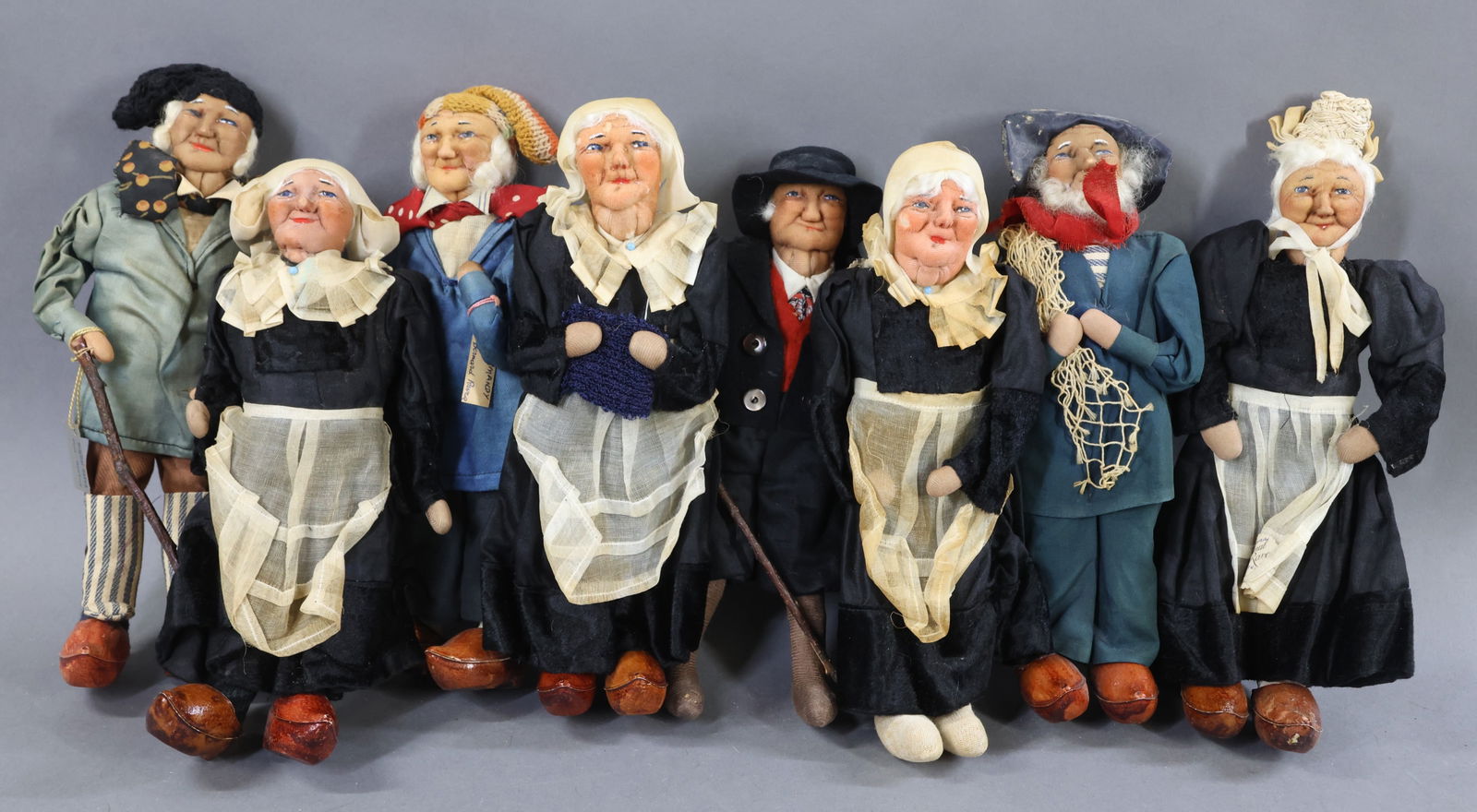 RAVCA.: LOT of (8) 10" Elderly Bernard Ravca dolls. All are marked Made in France or have a RAVCA tag. (4) Females dressed in identical outfits with different head coverings. (1) Doll is missing her clogs.