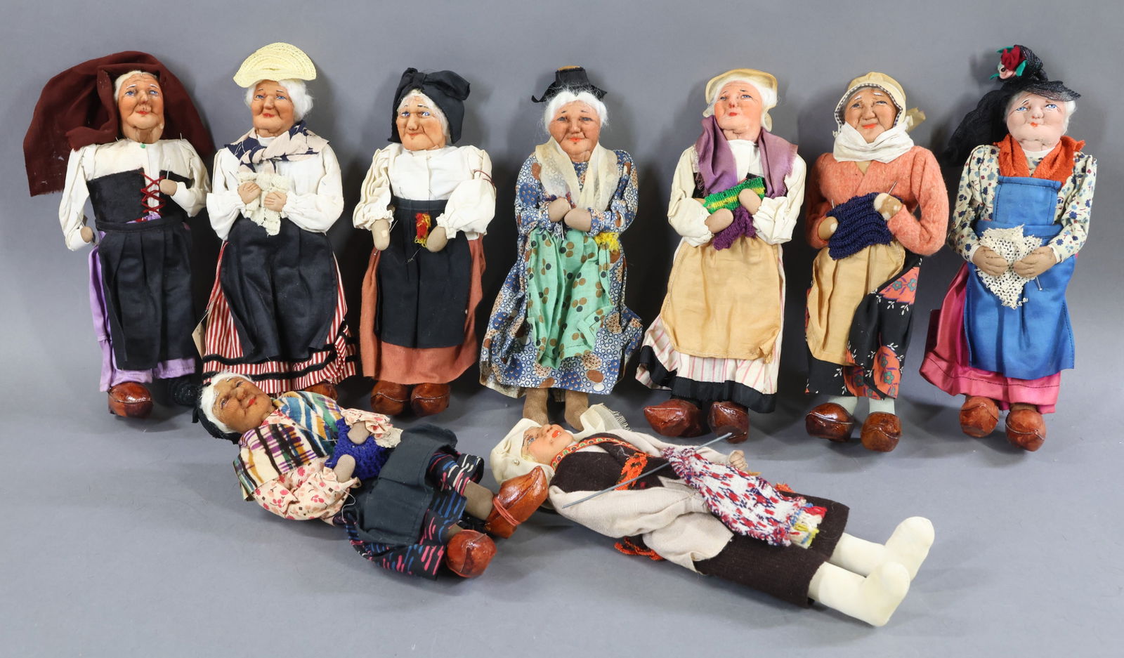 RAVCA.: LOT of (9) 10" Elderly Female Bernard Ravca dolls. All but (1) are marked Made in France or have a RAVCA tag. They are all dressed differently. Condition: (5) Clogs are missing. Age discoloration,