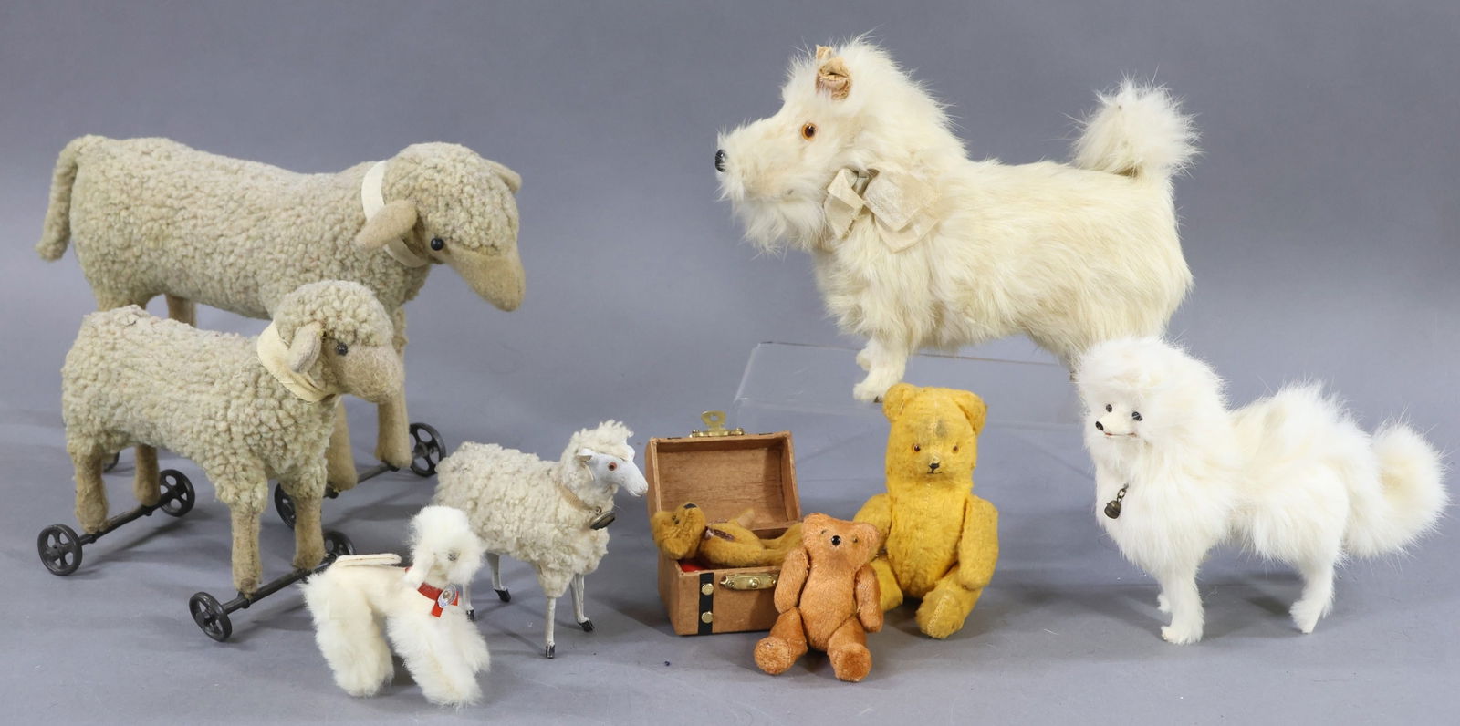 VINTAGE/OTHER ANIMALS.: LOT. VINTAGE - Lot of (3) white fur covered Dogs - 5 1/2" T. "Samoyed". Black glass eyes. When you squeeze his stomach, his mouth opens and tail wags. (In good working order.) 6" T Dog with amber glas