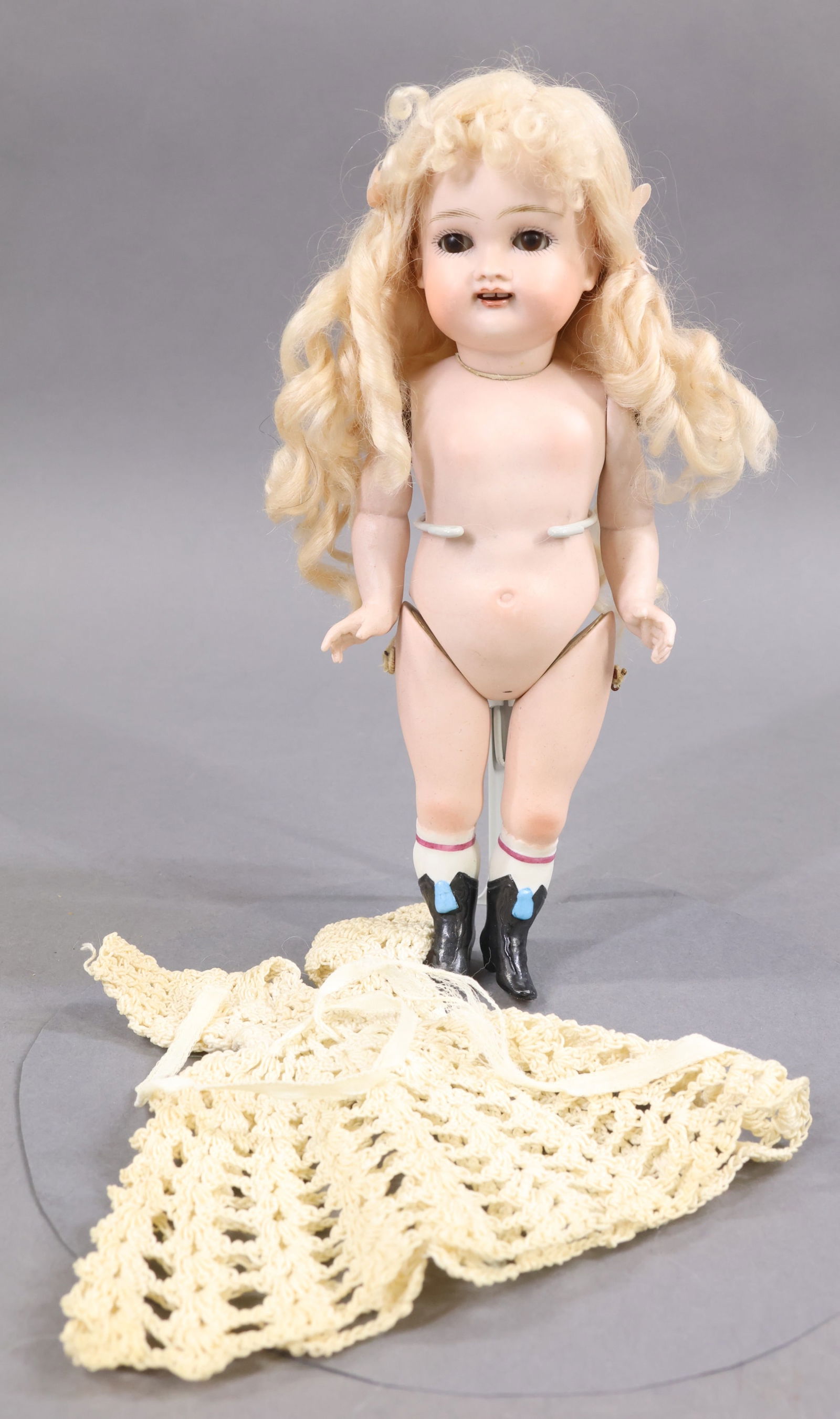 GERMAN ALL BISQUE DOLLS.: 8 1/2" "3" Doll with brown sleep eyes, open mouth (square cut teeth) , long curly pale blonde mohair wig. Swivel neck, 5 pc. body. Torso is marked III. Painted black boots with blue tassels. Comes wit