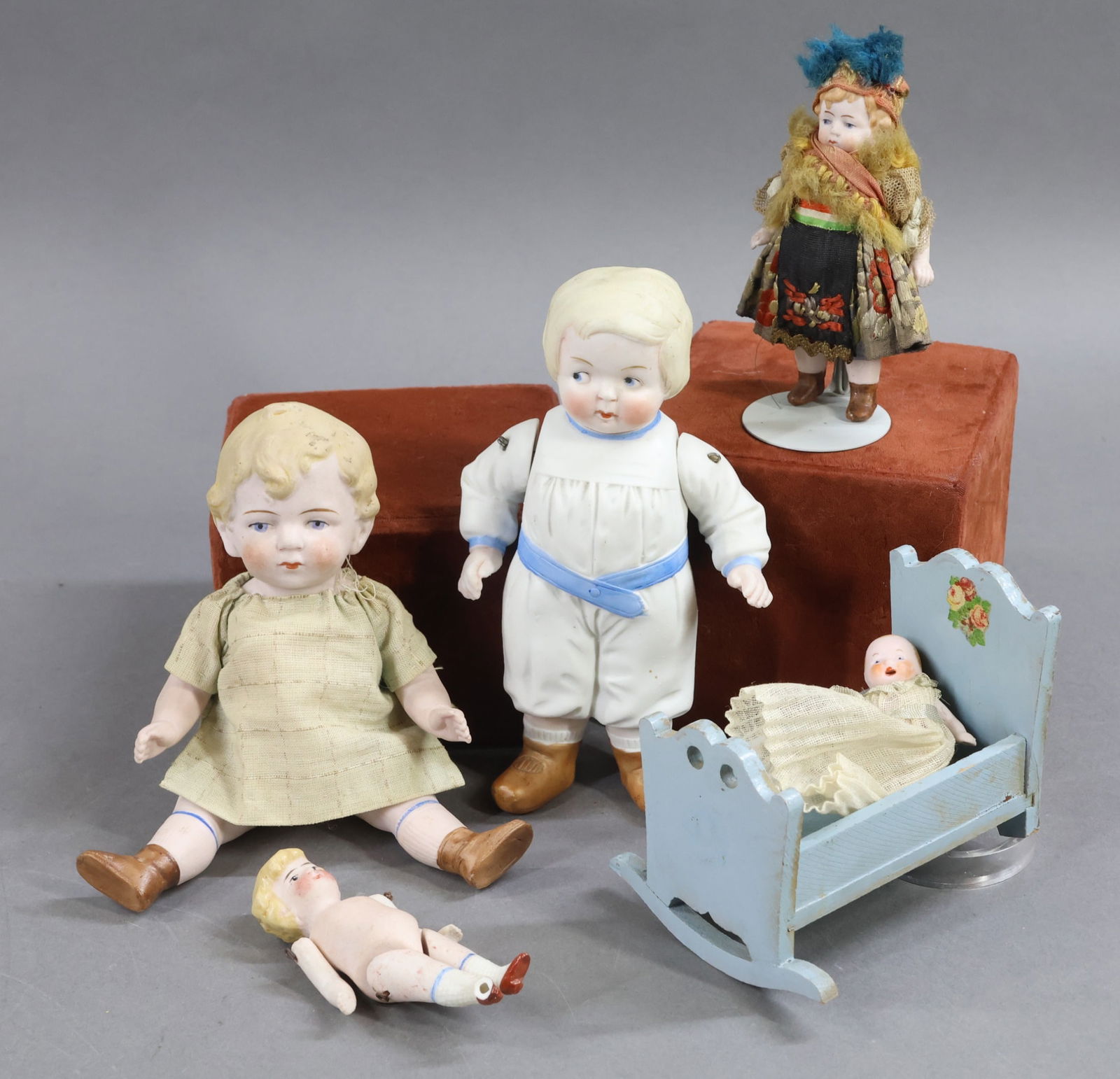 GERMAN ALL BISQUE DOLLS.: LOT of (5) dolls with painted features, hair. All but (1) have painted shoes/socks. 7" Unmarked pink bisque boy with brown boots. Vintage top only. Condition: needs restringing. 6 1/2" Boy dressed in