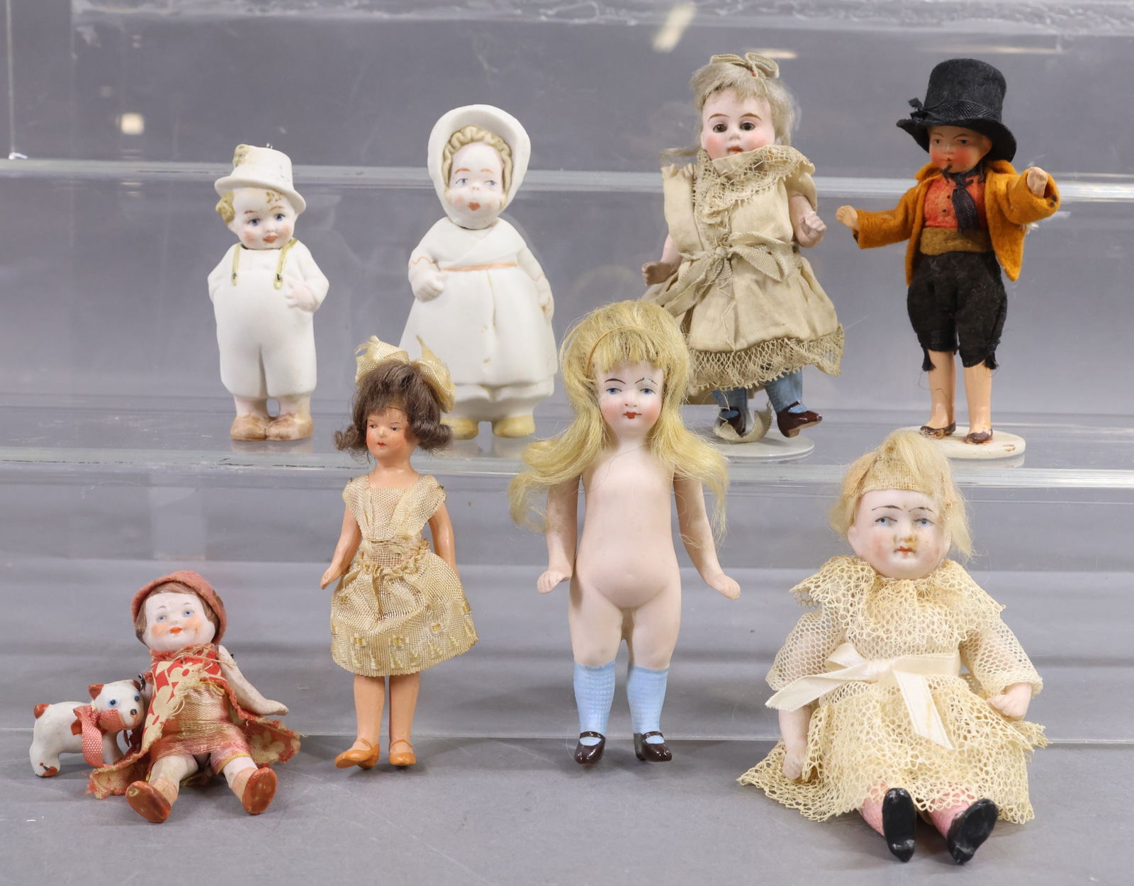 GERMAN ALL BISQUE DOLLS.: LOT of (8) dolls. All but (1) have painted eyes, (1) has glass eyes. (4) Have mohair wigs. Pair of 3", 3 1/4" Nodders, boy and girl. Pair of 4" painted bisque dolls, boy and girl. 3" Wire strung
