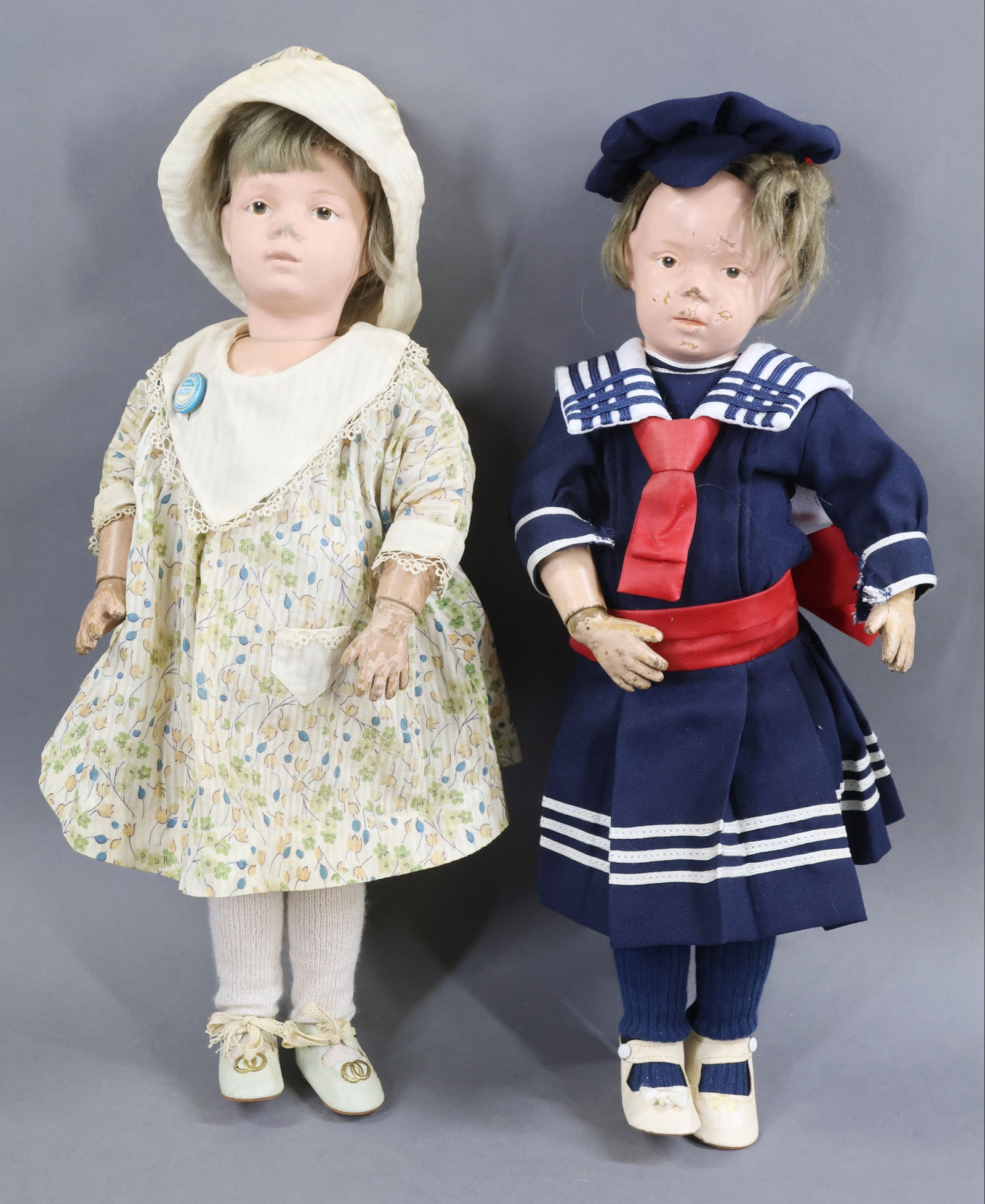 SCHOENHUT.: Pair of wigged female dolls. Both dolls have brown intaglio eyes and original tosca mohair wigs. They both have the incised marks on back of torsos. Doll 1) 16" Model No. 301. Dressed in newer