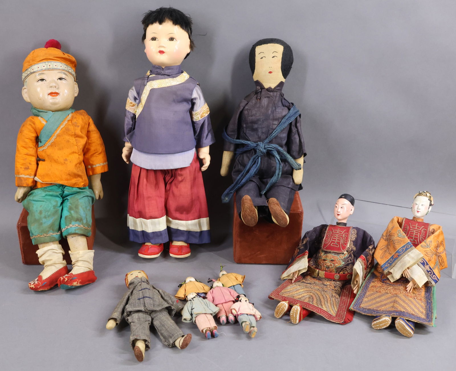 DOLLS REPRESENTING FOREIGN COUNTRIES.: LOT of (11) all original dolls from China. Pair of 11" Opera dolls with composite heads. Condition: age loss on females head. (5) 3" Cloth dolls. 7 1/4" Cloth child doll and 15" cloth adult doll both