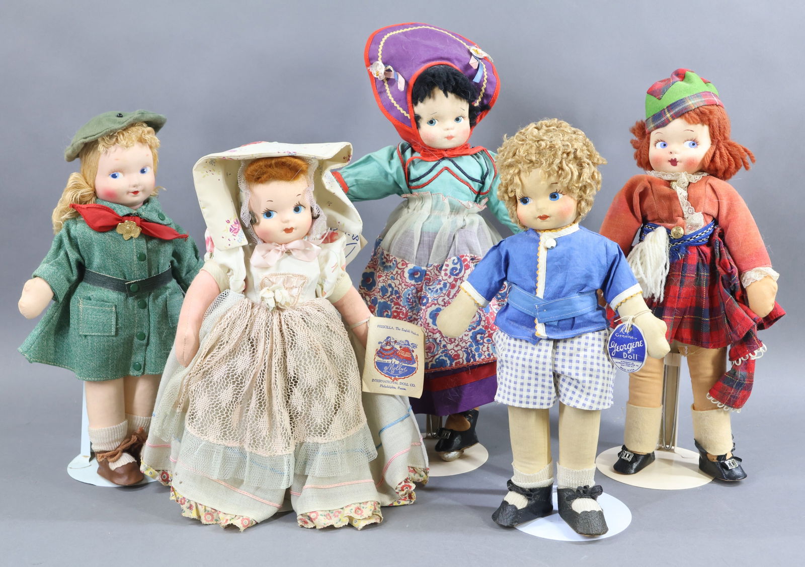 AMERICAN CLOTH DOLLS.: LOT of (5) all original 1930's-1940's mask face dolls, (3) with original hang tags. Tagged 13" GEORGENE Averill Boy doll. Unmarked GEORGENE 13" Girl Scout with pin. (3) 14" MOLLY-'ES dolls - tagged "K