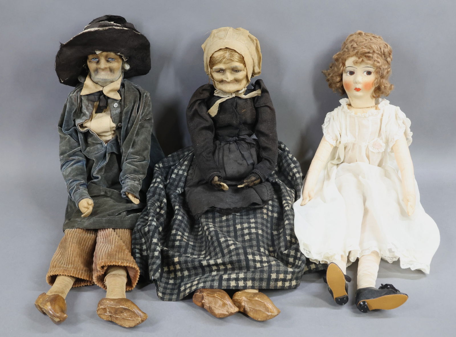 CLOTH DOLLS.: LOT of (3) unmarked mask face boudoir type dolls. All of them have painted features and are wearing antique clothing, shoes. 24" Lady doll with side glance eyes, curly brown mohair wig. Cotton clothin