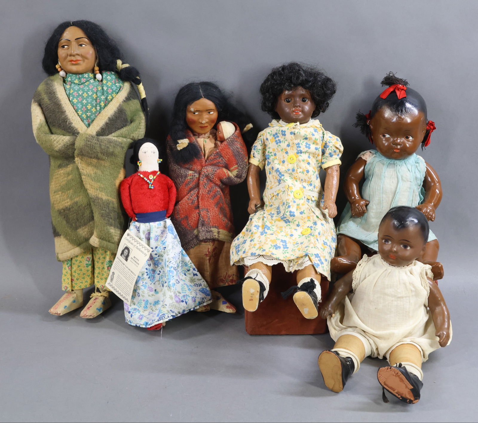 BLACK & NATIVE AMERICAN DOLLS.: LOT of (3) Black dolls and (3) Native American dolls. Black dolls - 12" Unmarked composition "Totsy" type doll with painted features, black floss hair coming out of (3) drilled holes in head. Vintage