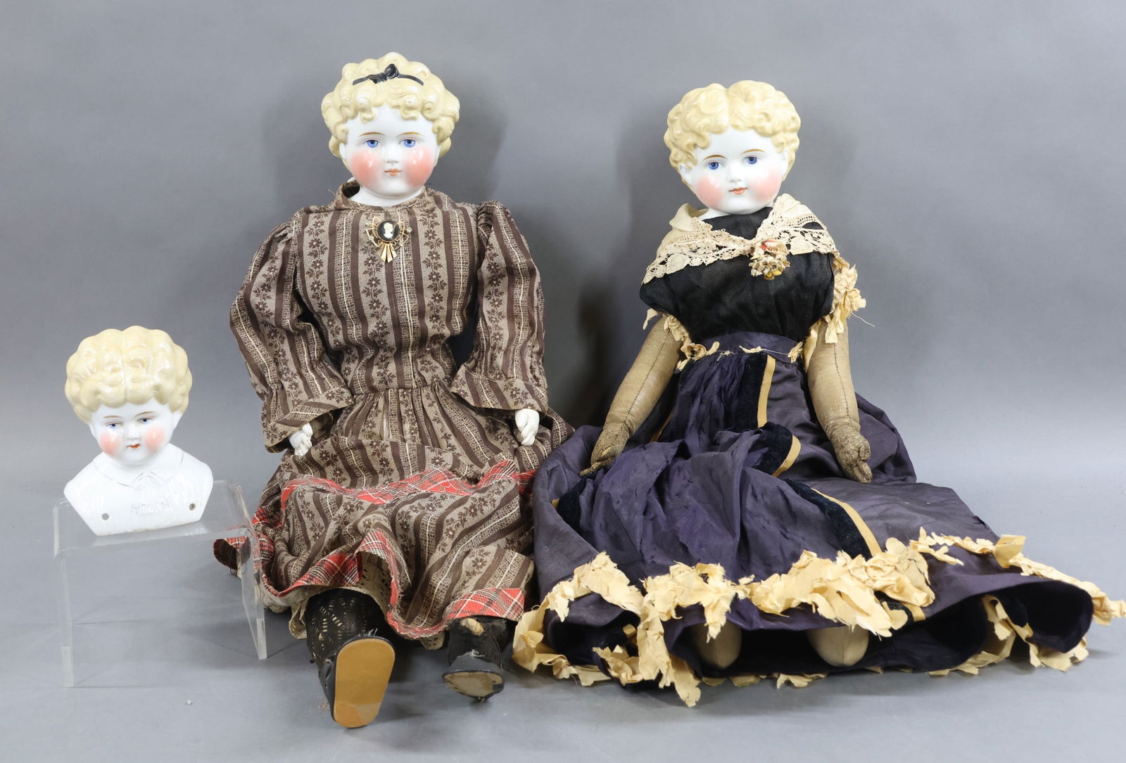 CHINA DOLLS.: Pair of antique dolls and a "Pet Name" shoulder head with molded blonde hair, painted blue eyes. Doll 1) 24" with short center part hair style. Original cloth body with camel leather arms, individual