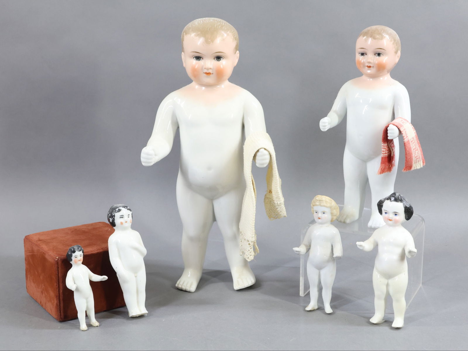 CHINA DOLLS.: LOT of antique "Frozen Charlotte" or "Bathing" style dolls. 3 3/4" - 13" With blue eyes. The (2) largest 9", 13" have blonde hair, painted heads. They each have a towel over their arm. 5 1/2" Has