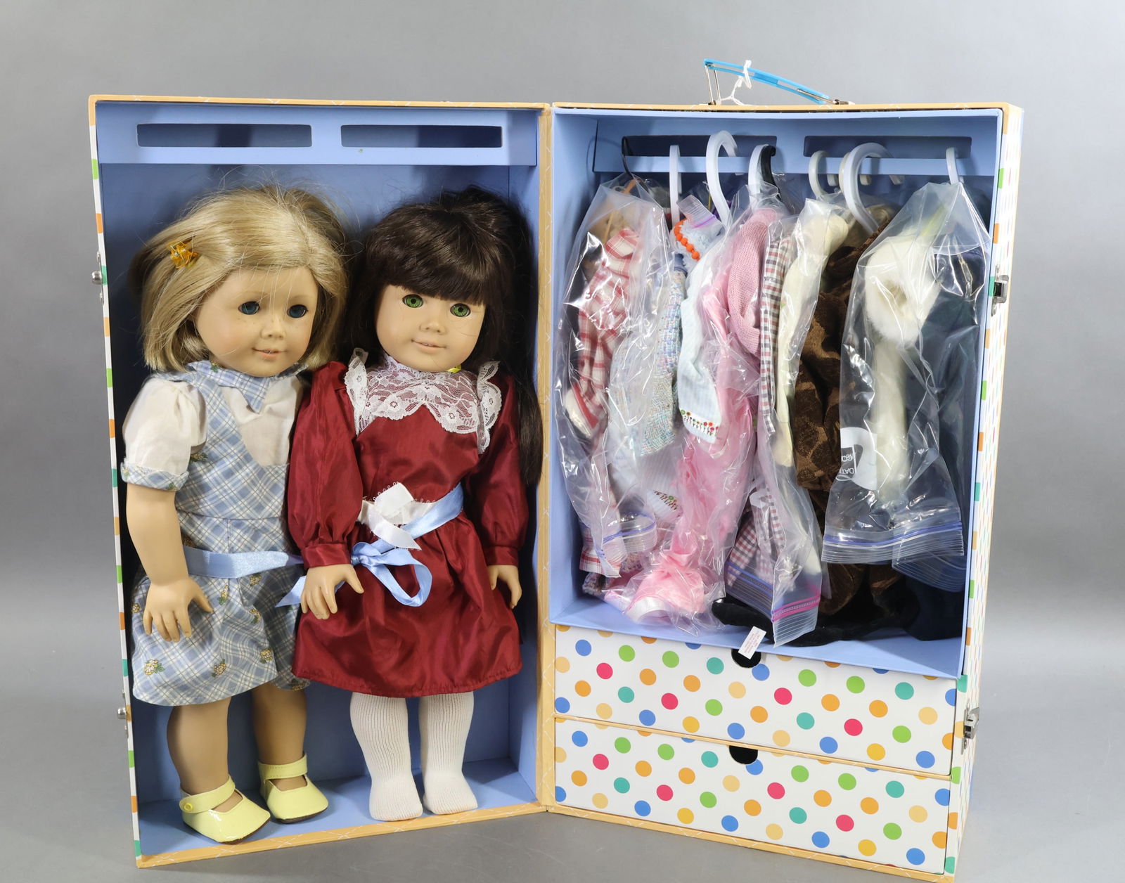 AMERICAN GIRL.: LOT. Cardboard trunk with (2) dolls and misc. clothing. "Kit" and "Samantha". Additional outfits include: Clothes for Kit, Samantha, Samantha's Winter Outfit. Handmade clothing. Condition: lot has