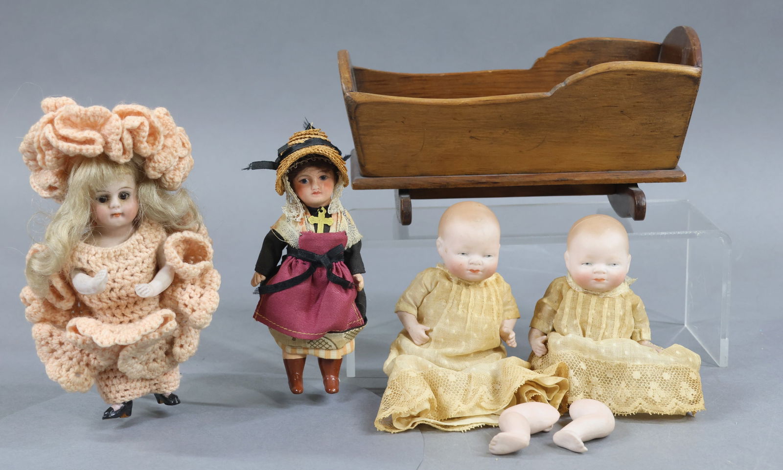 BISQUE DOLLS, 12" UNDER.: LOT of (4) antique dolls. Pair of 5" all bisque "Byelo Babies" 20-12 with painted features, hair. 5 Pc. bodies, (1) with the round paper label on chest. (1) Doll is in a 7" wooden cradle marked on