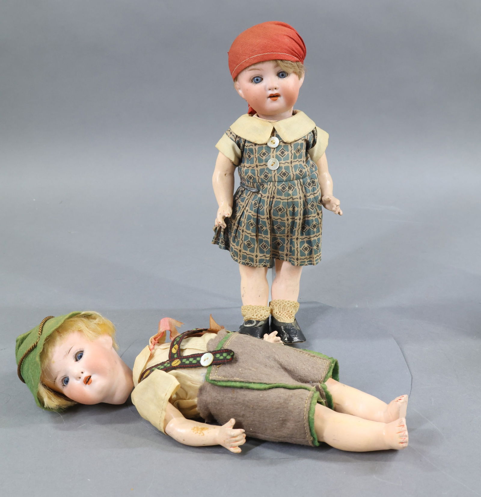 BISQUE DOLLS, 12" UNDER.: Pair of antique German dolls. 9" HEUBACH KOPPLESDORF 320 - 14/0 with blue sleep eyes, open mouths, mohair wigs, 5 pc. papier mache toddler bodies. Both appear to be wearing original clothing. Girl -