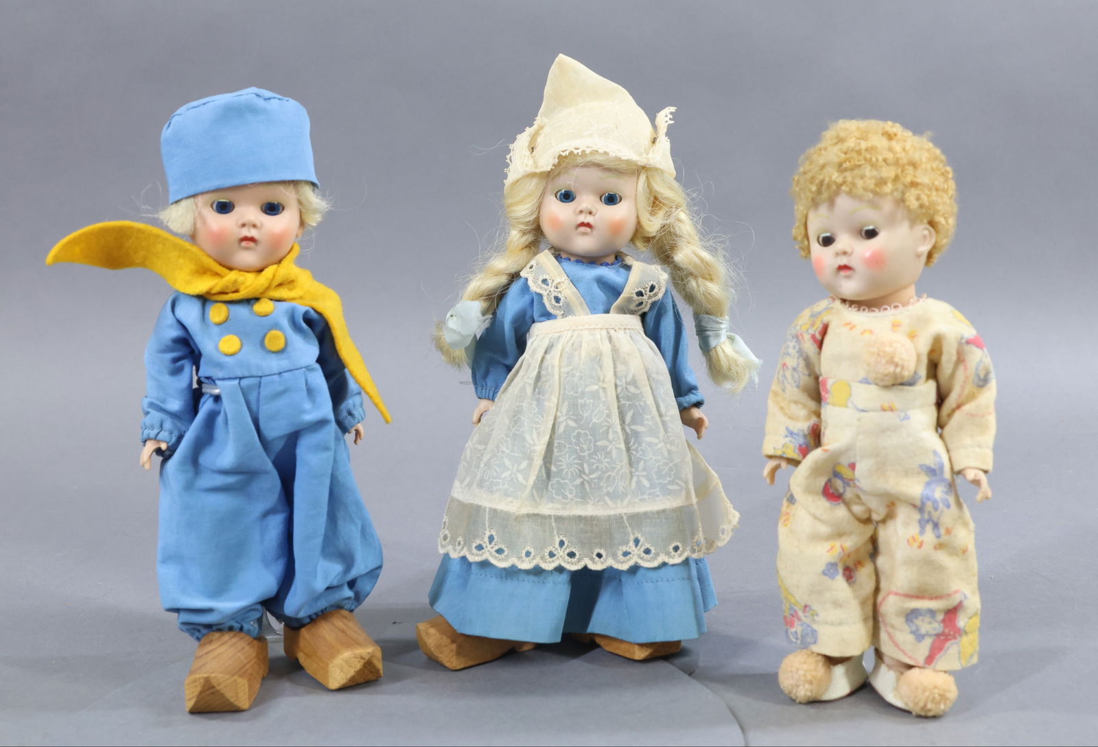 1940's-1960's DOLLS.: LOT of (3) 8" VOGUE 1950-1953 "Ginny" dolls with painted eyelashes, strung. Pair - Dutch boy and girl in original tagged outfits, wooden clogs. Blonde synthetic wigs. Also, doll with caracul wig,